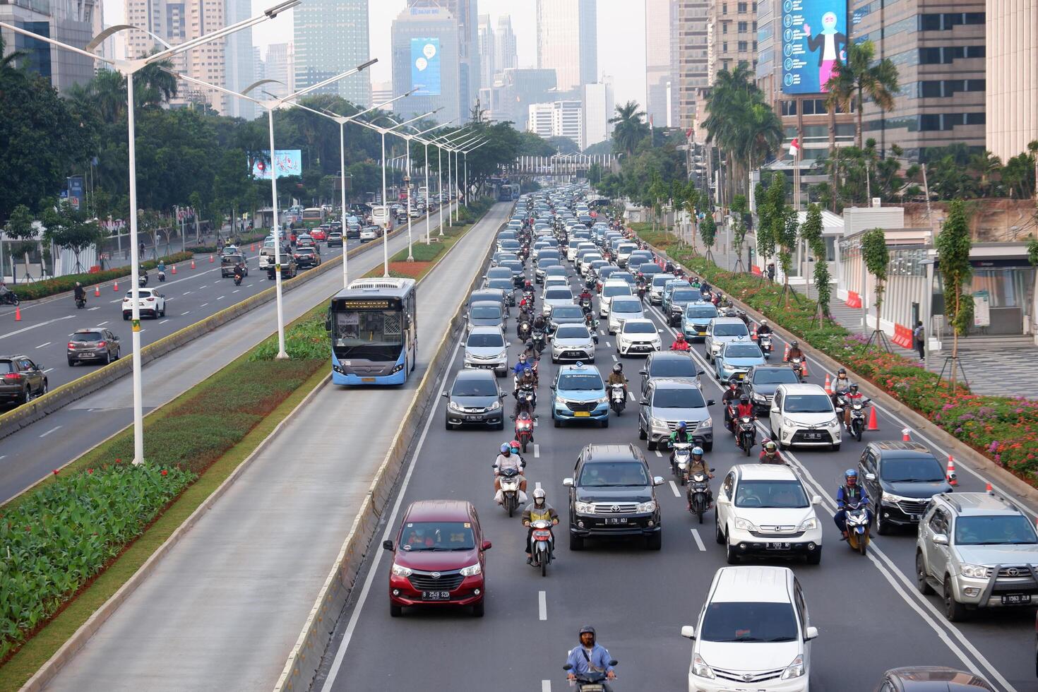 Jakarta traffic jam in the business center and offices main road of Jakarta. Traffic congestion after office hours on weekdays after social restriction of pandemic Covid-19 photo