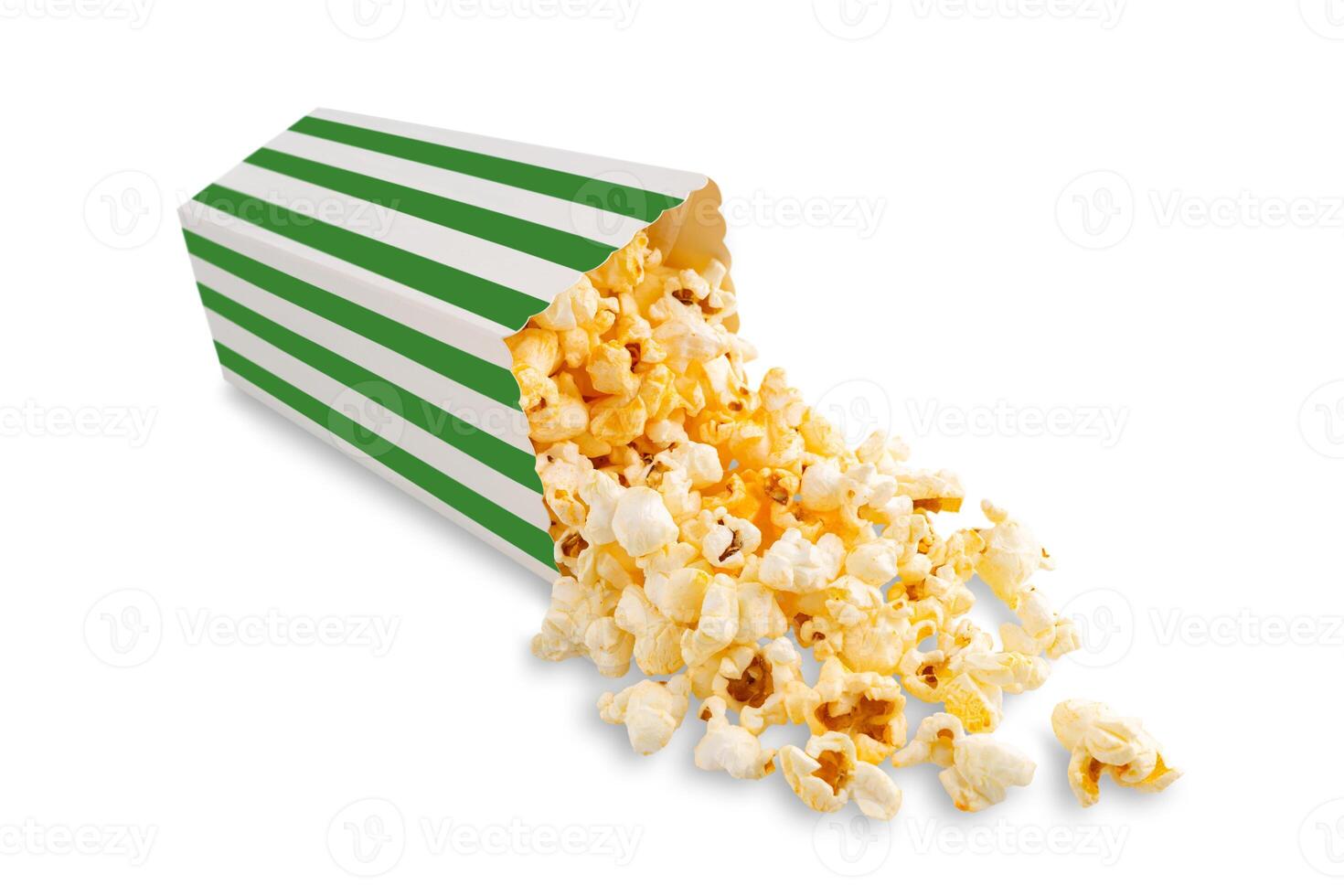 Tasty cheese popcorn falling out of a green striped carton bucket, isolated on white background photo
