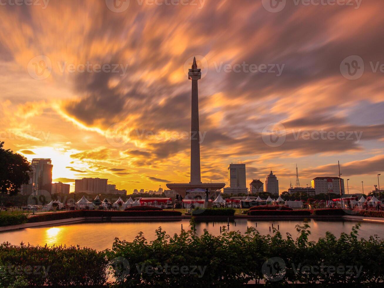 Beautiful landscape of Monas Monument in Medan Merdeka Square, Jakarta in the cloudy sunset in long exposure photography mode photo