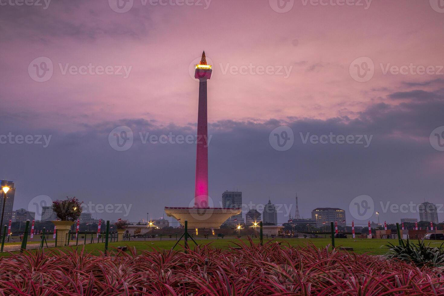 Beautiful landscape of Monas Monument in Medan Merdeka Square, Jakarta in the cloudy sunset photo