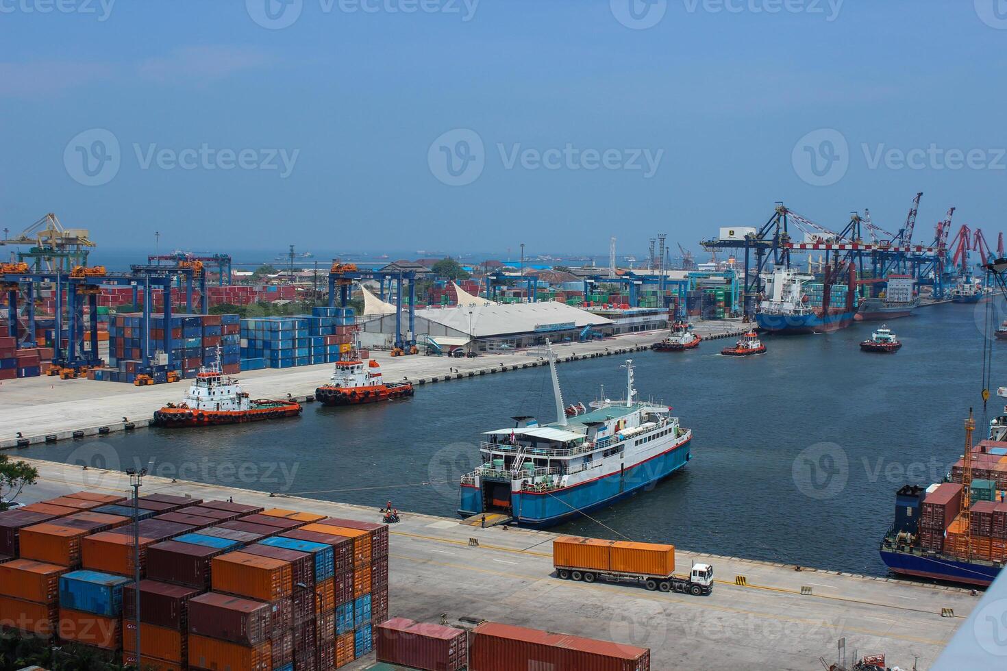 Aerial view of port with cranes and shipping containers, large ships ready for load the cargo photo