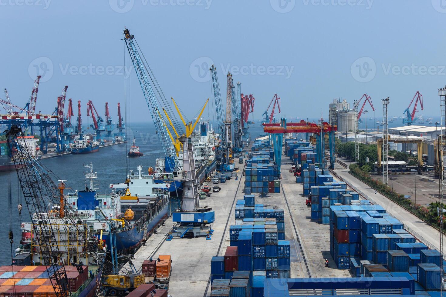 Aerial scenery of port with cranes and shipping containers, cranes move the shipping container to unload from cargo ships photo