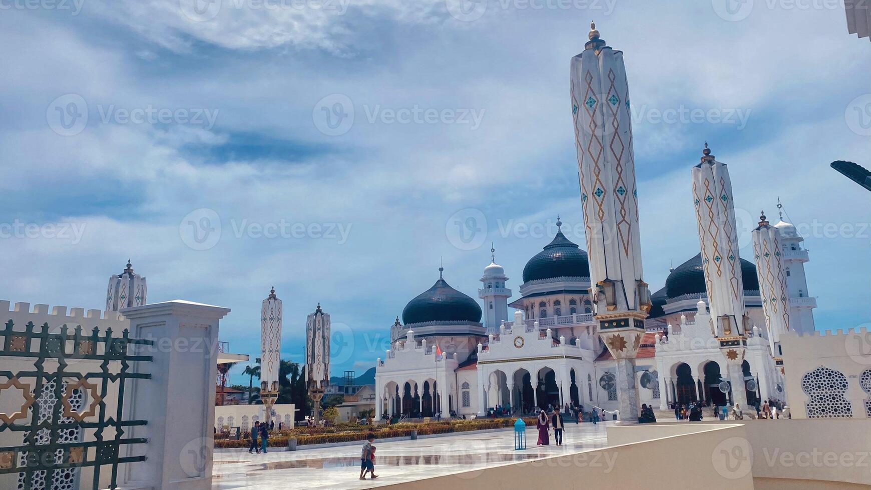 Beautiful view of Baiturrahman grand mosque banda aceh with blue sky and cloudy photo