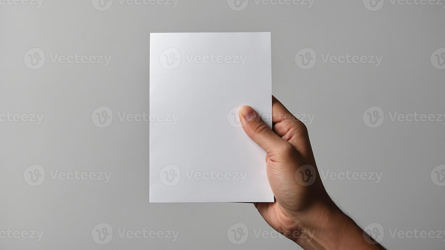 A person holding up a blank sheet of paper photo