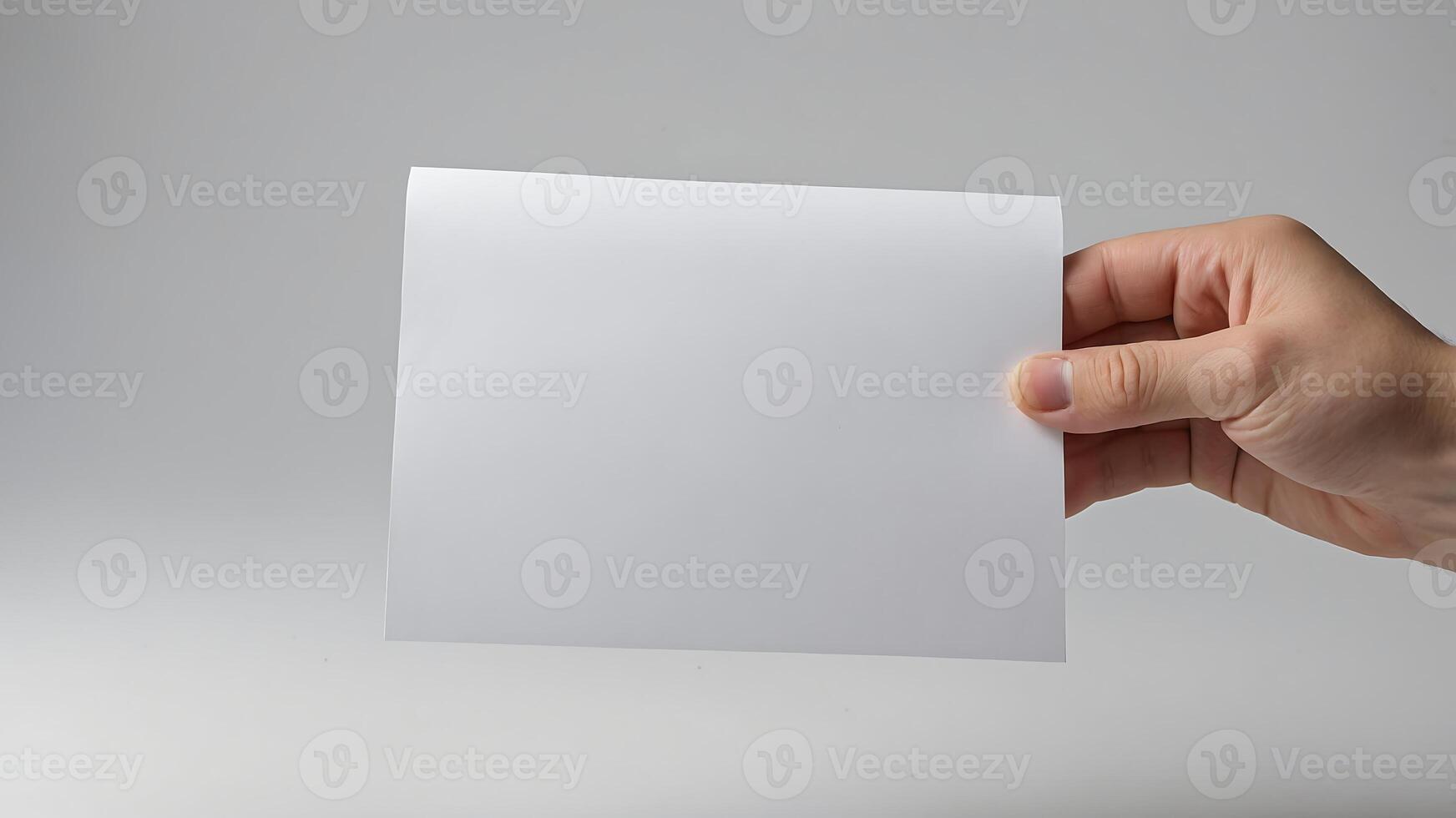 A person holding a blank piece of paper photo