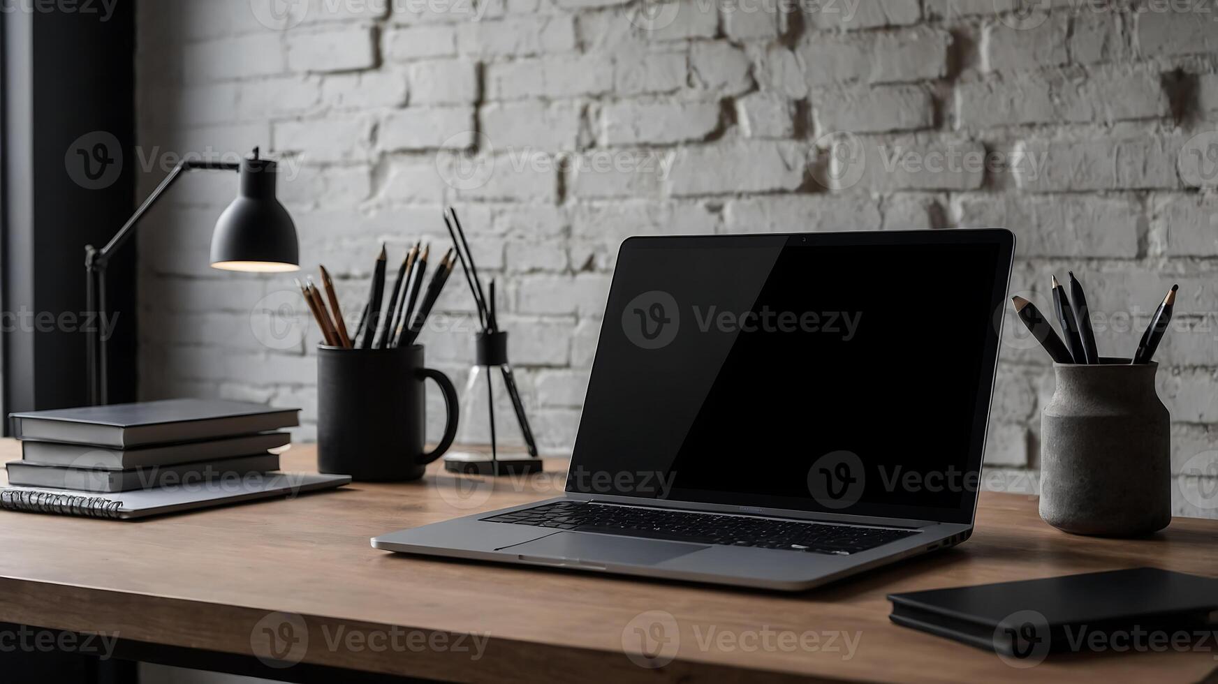 A laptop is sitting on a wooden desk next to a lamp photo