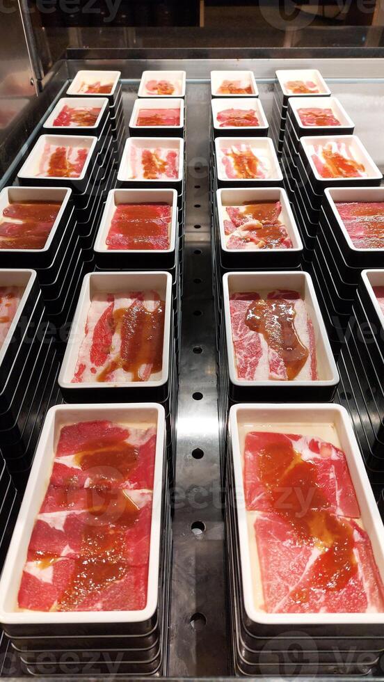 Fresh variant beef raw sliced with marbled texture served for Shabu or Yakiniku photo
