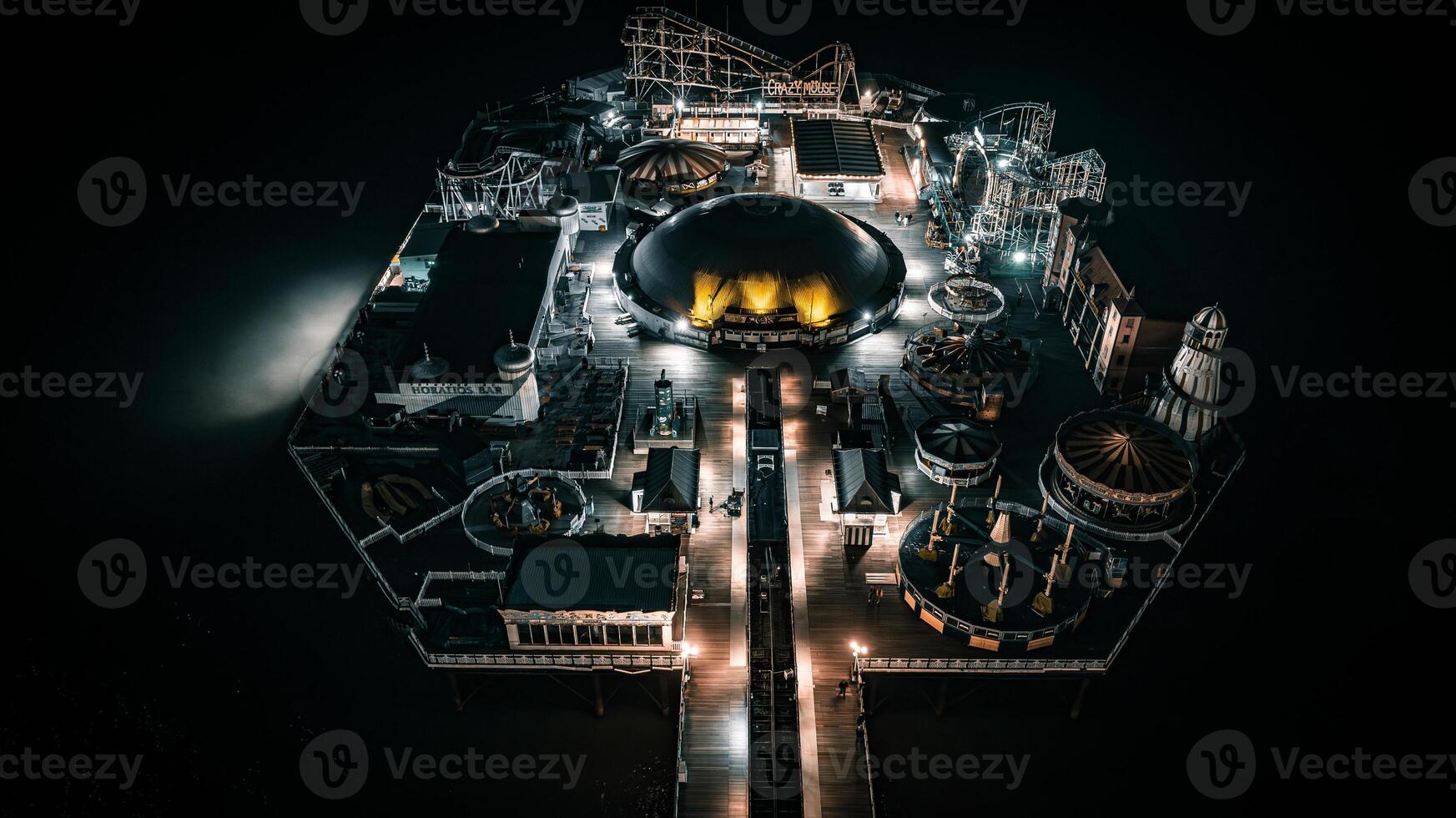 Aerial view of a seaside, Brighton Pier and beach in night lights, Brighton, East Sussex, UK photo