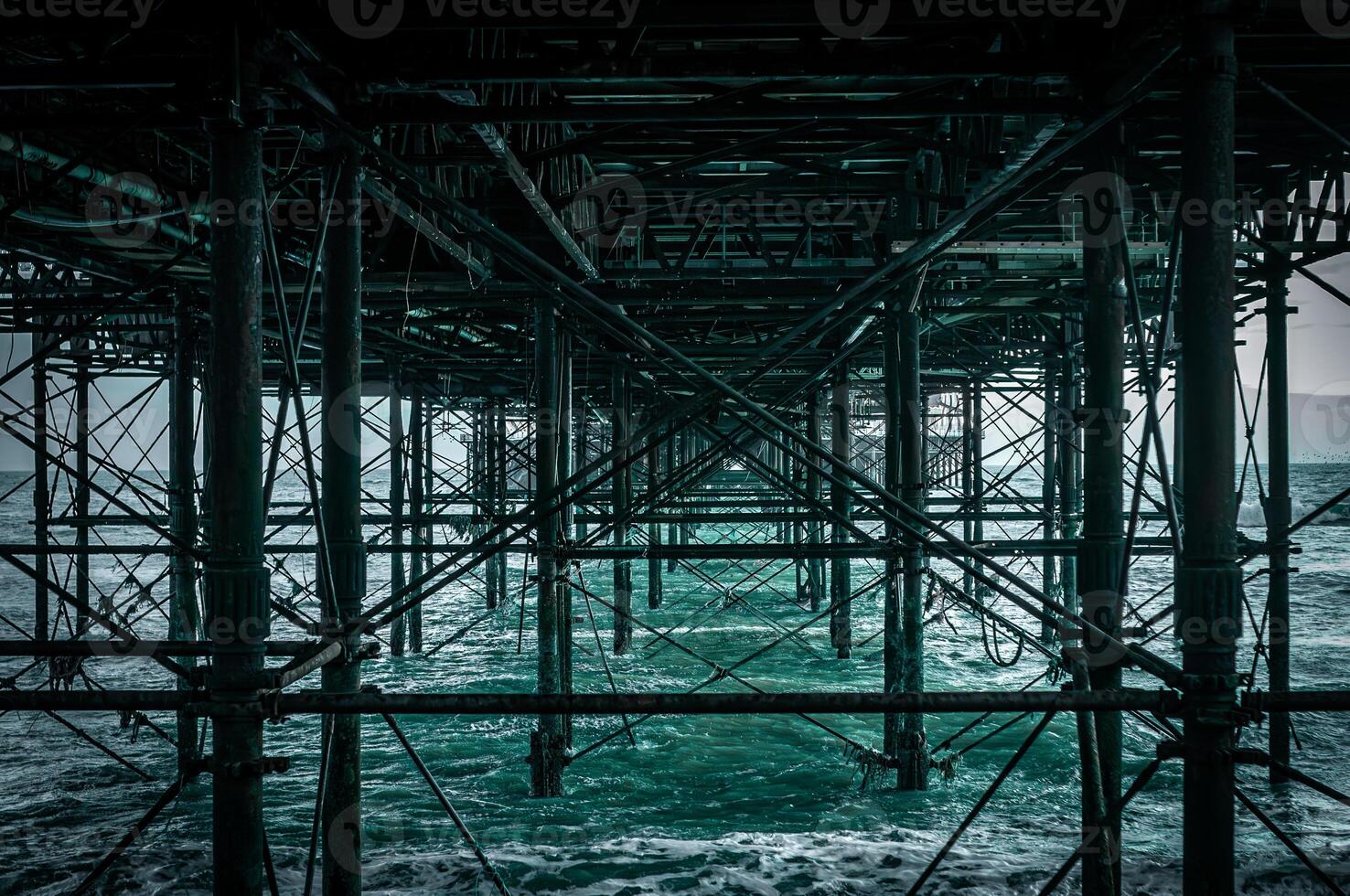 Structure of the pier base in Brighton, looks like scaffolding in blue water, East Sussex, UK photo