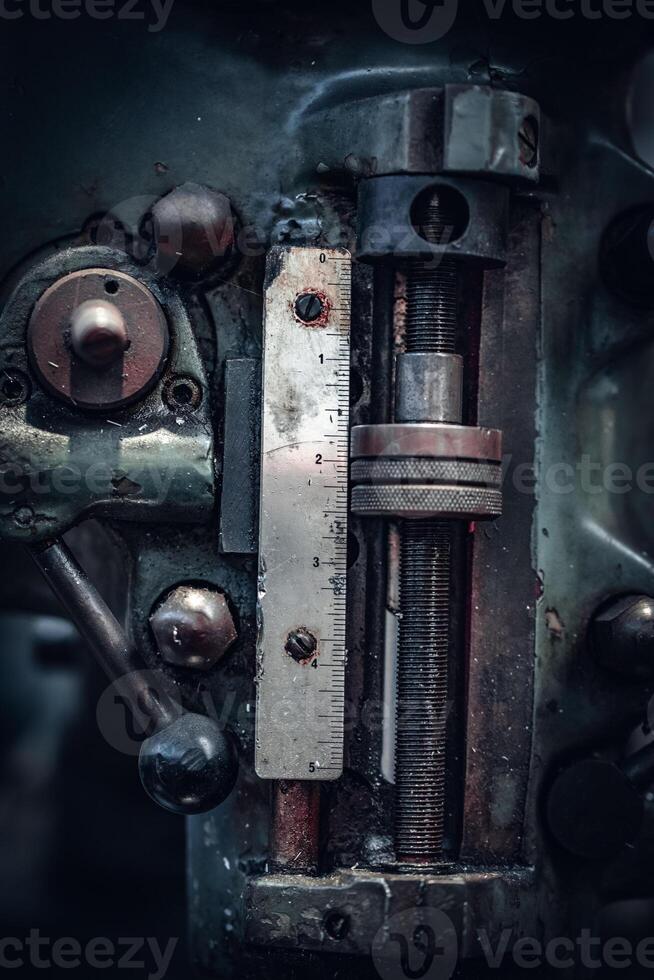 Close up of old mill machine with scale on top, old metal workshop photo