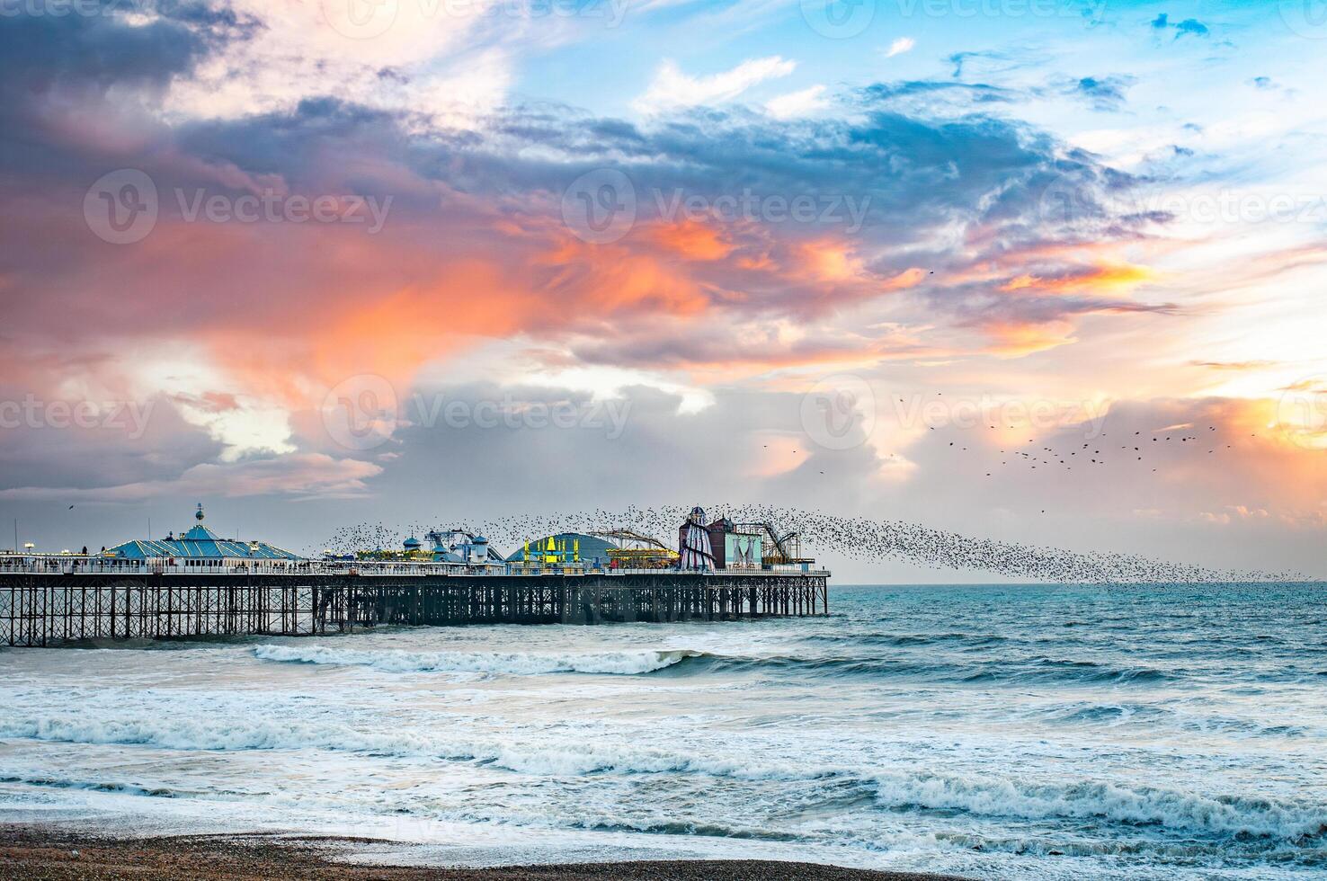 Murmuration around Brighton pier winter time as Starling bird return, East Sussex, UK photo