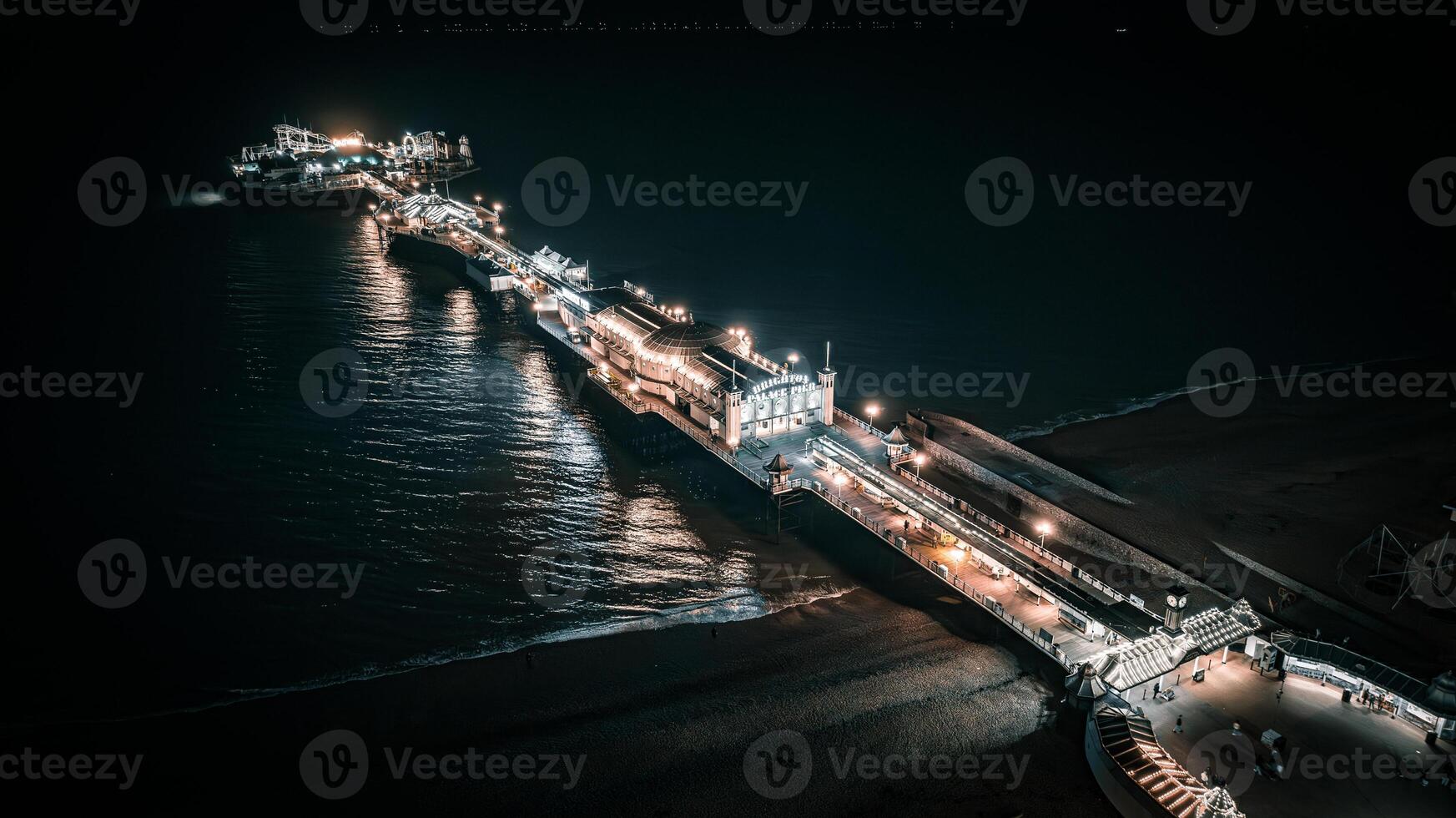 Aerial view of a seaside, Brighton Pier and beach in night lights, Brighton, East Sussex, UK photo