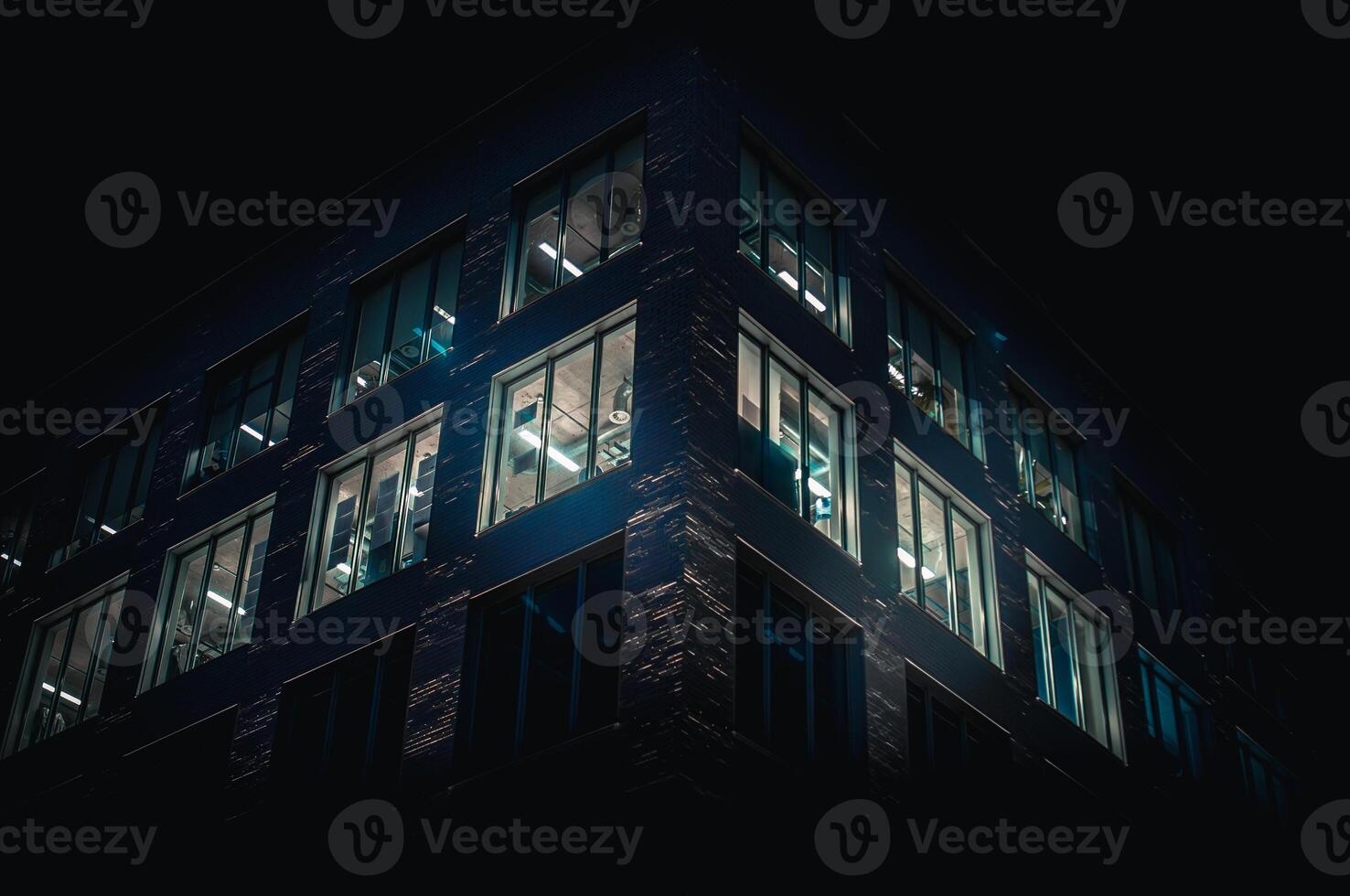 Office building at night where window glowing blue, Brighton, East Sussex, UK photo