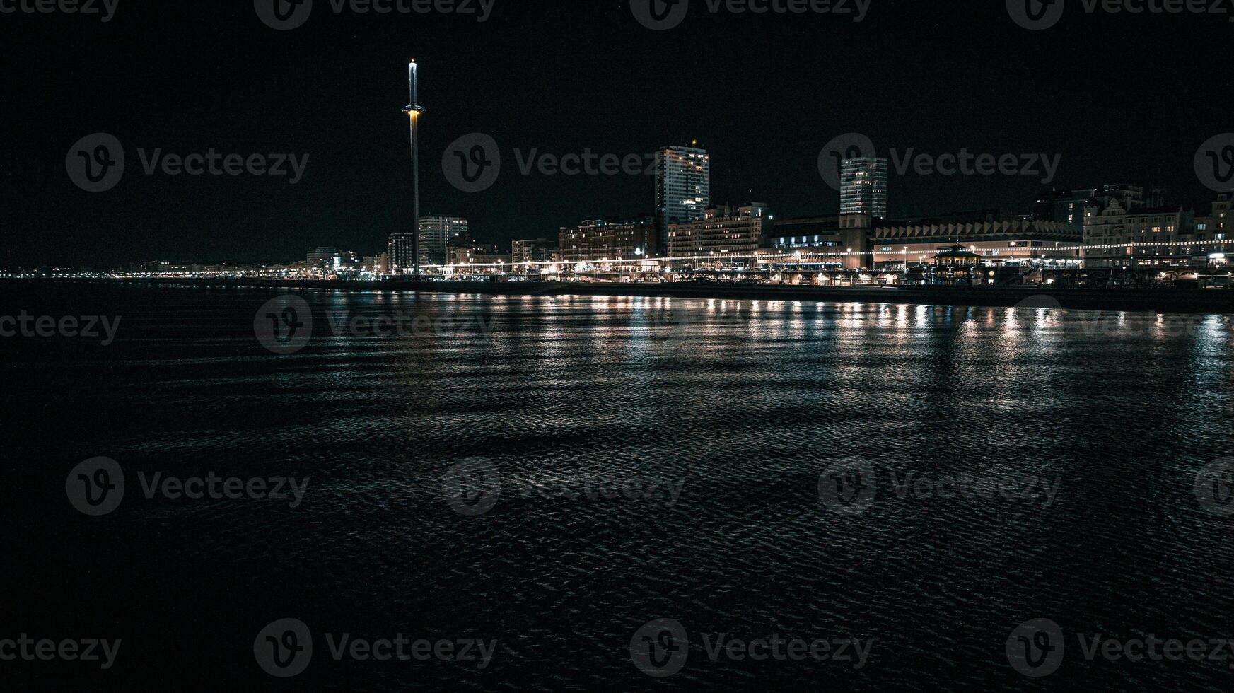Brighton beach and night lights of the town, Brighton and Hove, East Sussex, UK photo