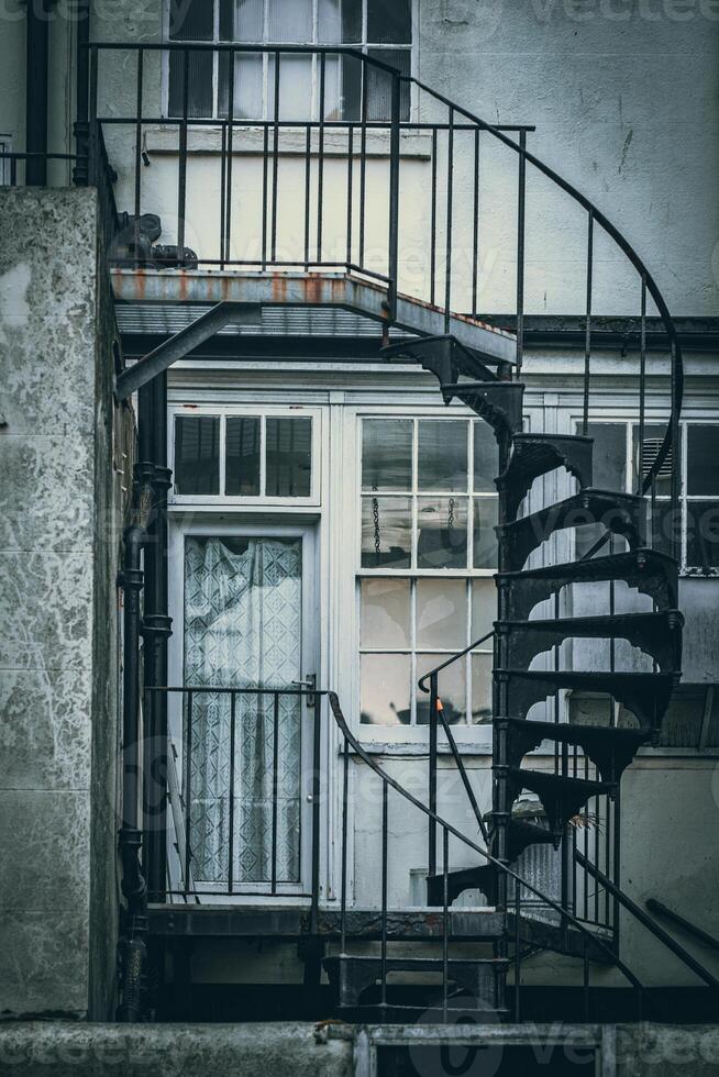 Spiral fire exit stair on a back side of a residential old build houses, Brighton, East Sussex, UK photo