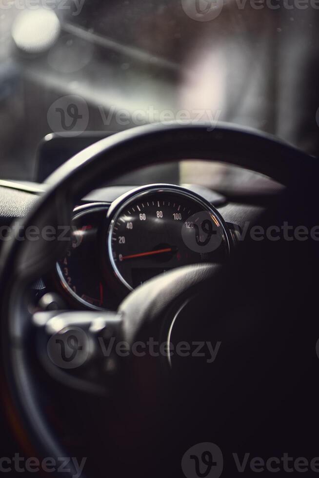 Speedometer instrument cluster visible in a shadow. photo