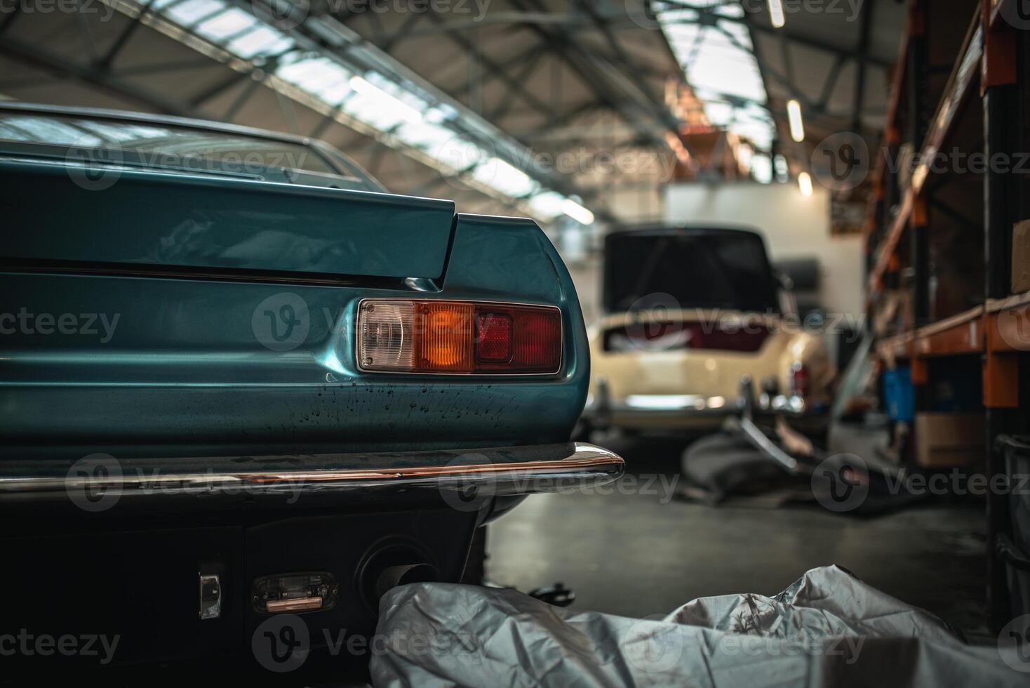Classic cars being restored in a vintage vehicle garage workshop photo