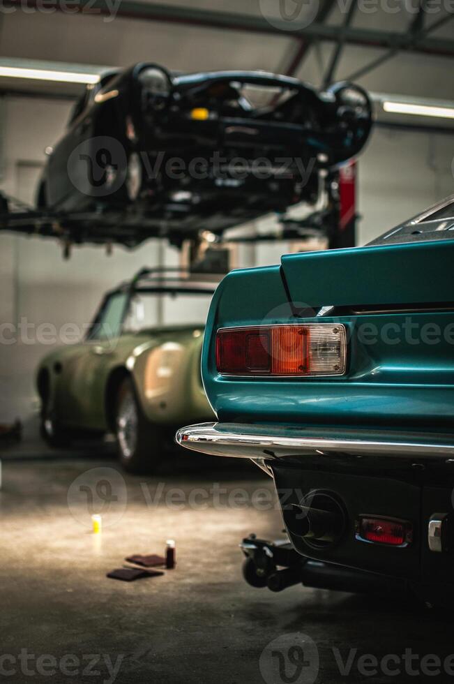 Classic cars being restored in a vintage vehicle garage workshop photo