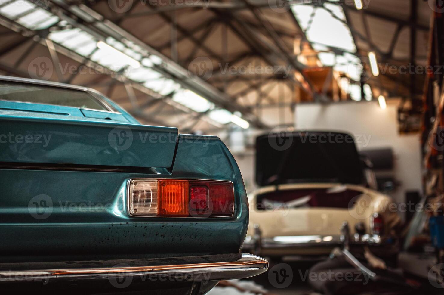 Classic cars being restored in a vintage vehicle garage workshop photo