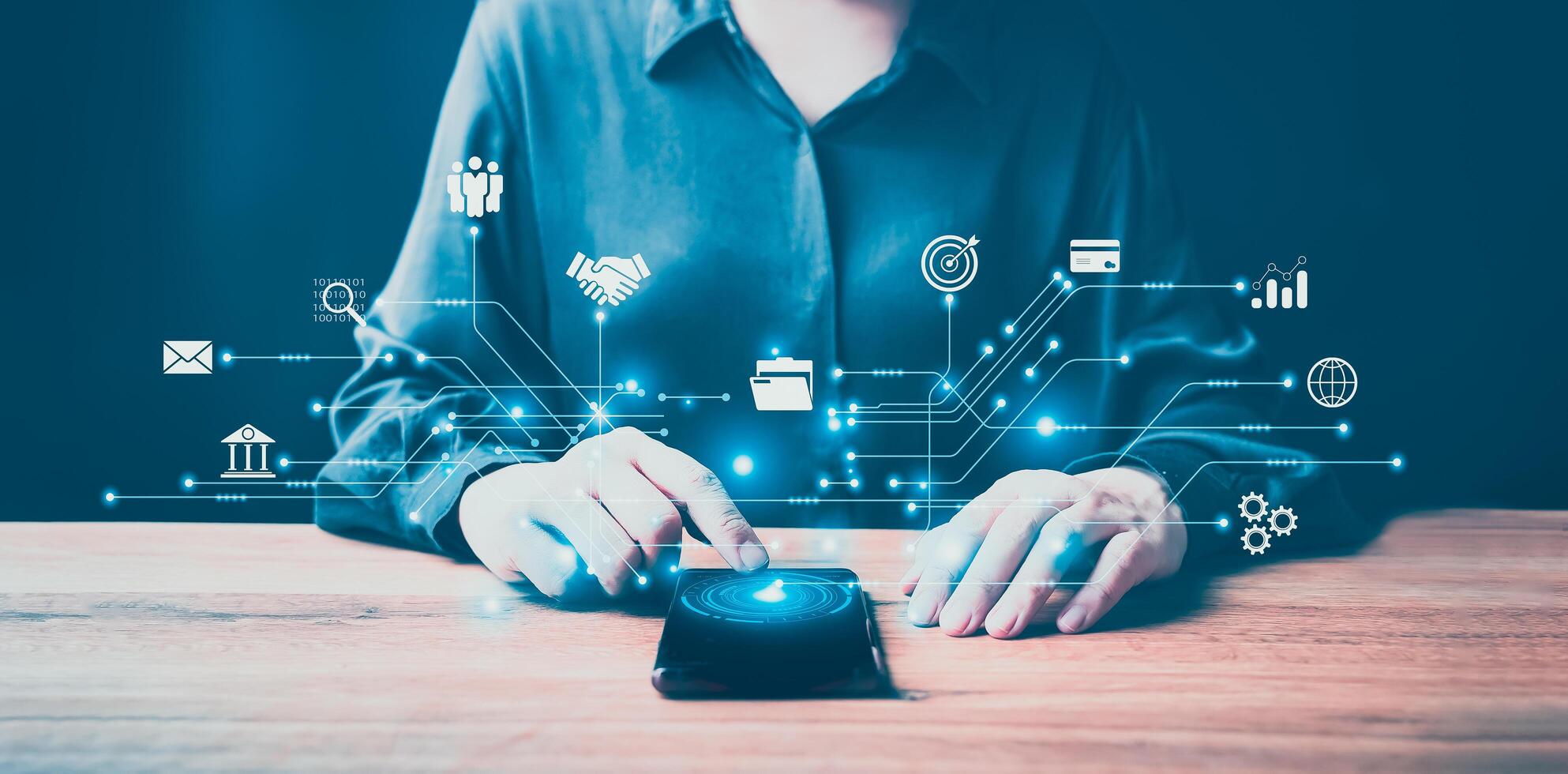 Businesswoman using computer mouse with icons on table photo