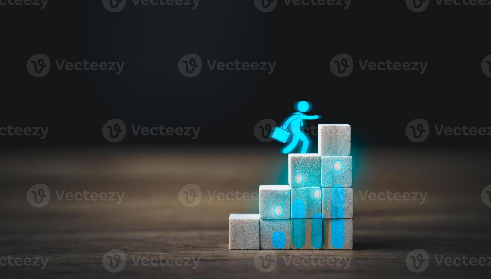A man is climbing up a ladder made of blocks photo