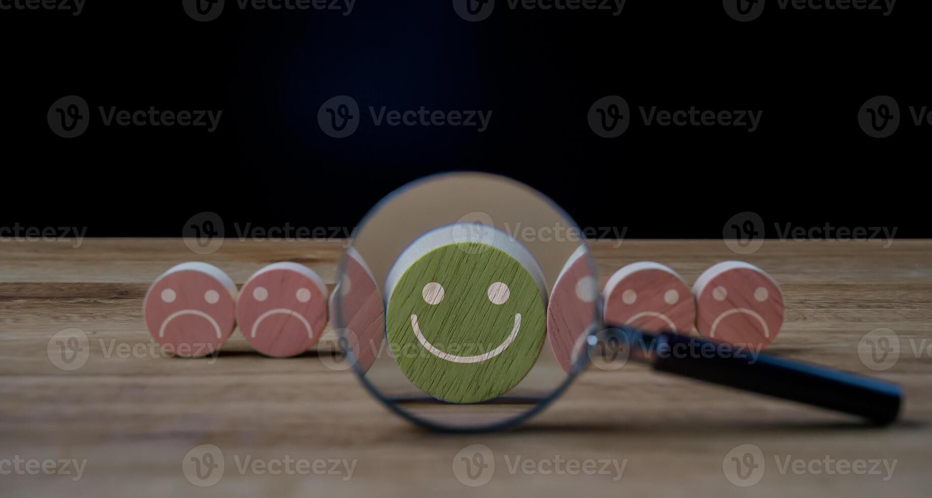 A magnifying glass is looking at a smiley face photo