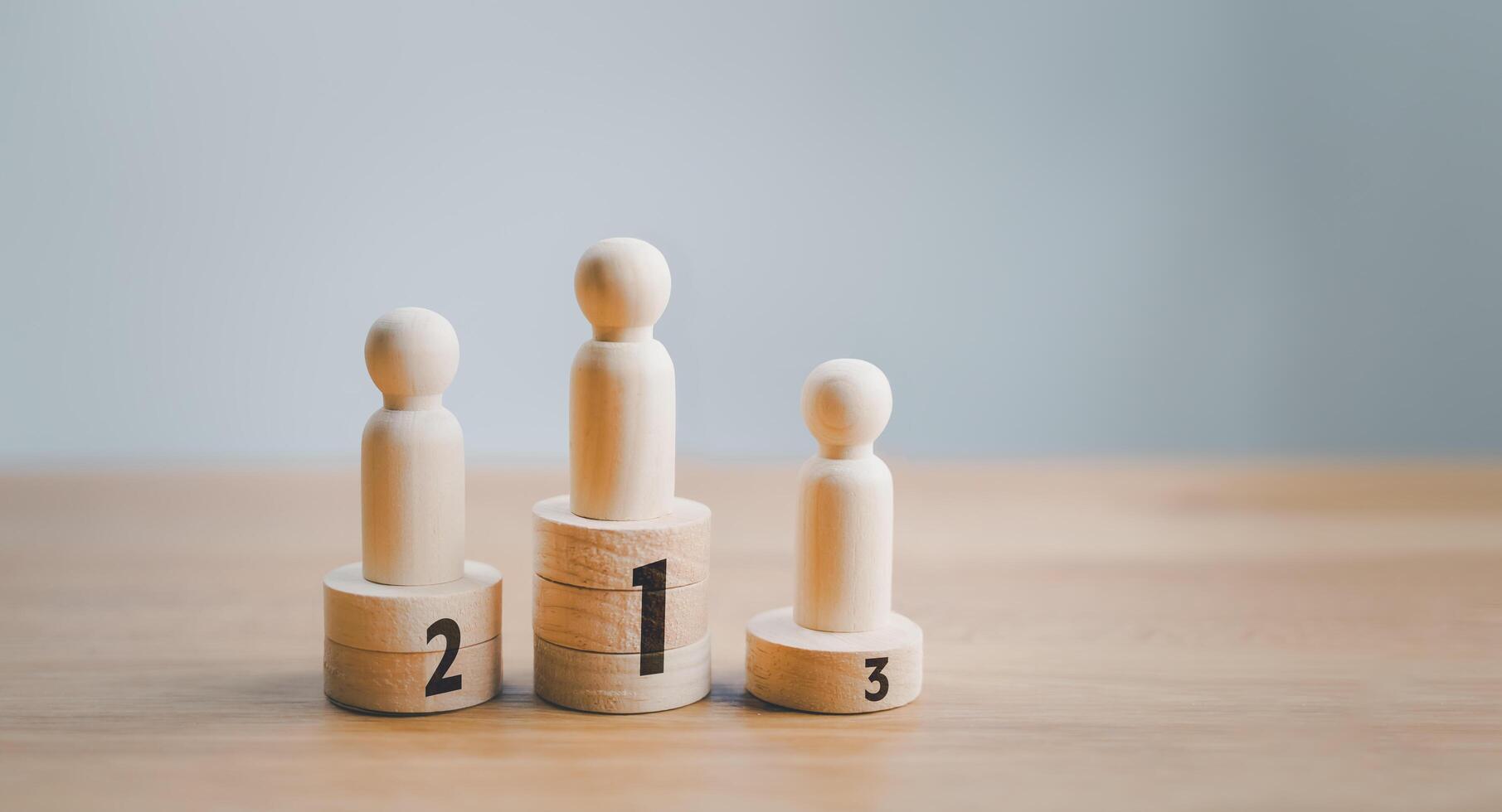 Three wooden figures standing on top of each other photo
