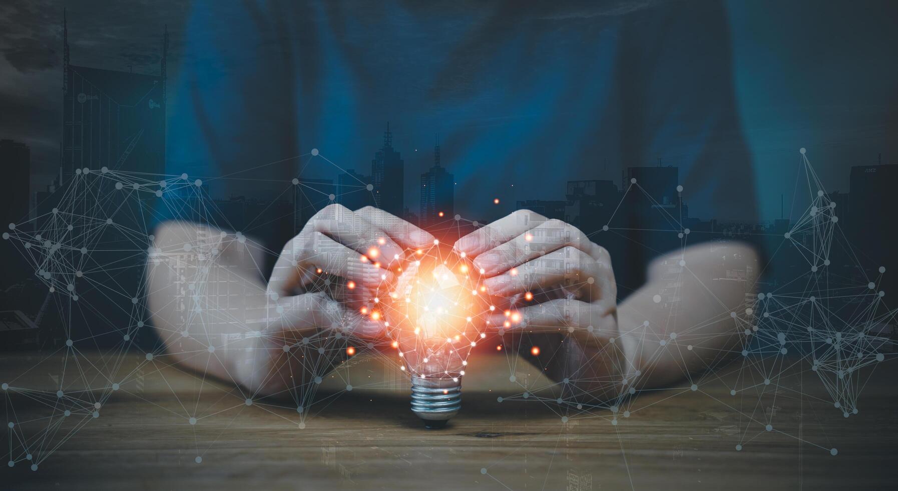 A person holding a light bulb with a network connection photo
