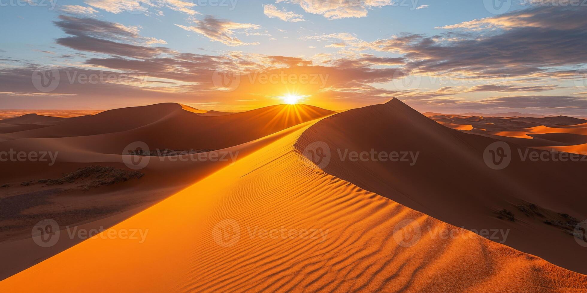 The sun setting behind towering dunes, casting long shadows across the desert photo