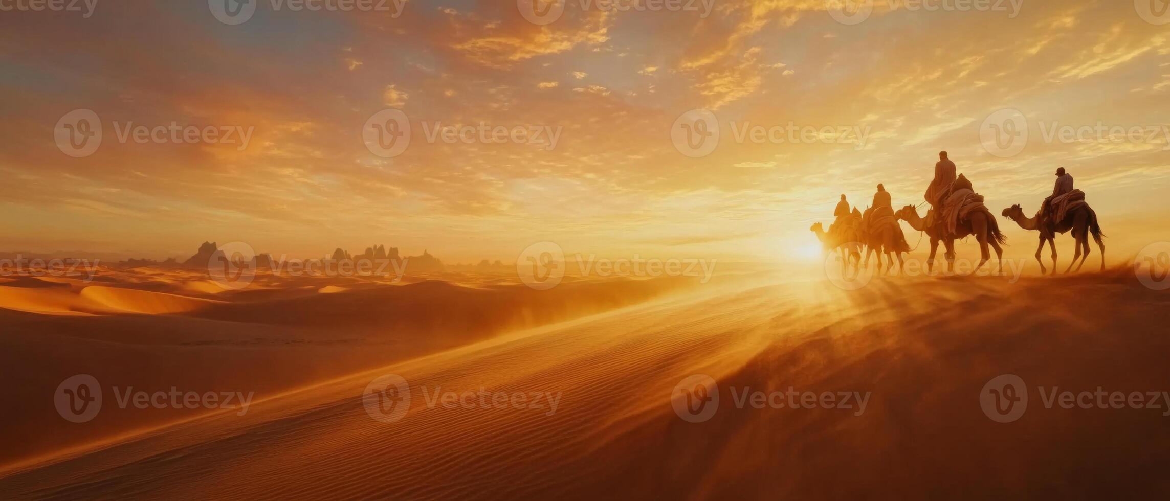 A camel caravan crossing vast desert dunes at dusk, warm light on the sand photo