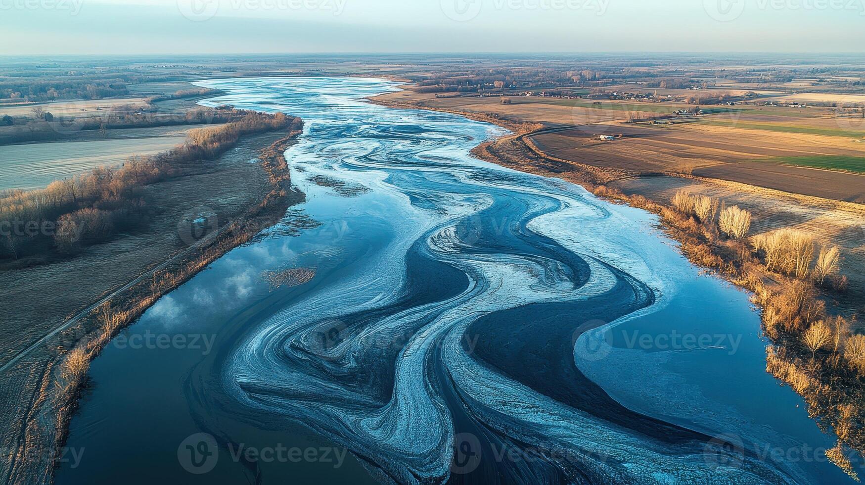 Aerial view of a winding river with ice patterns. photo
