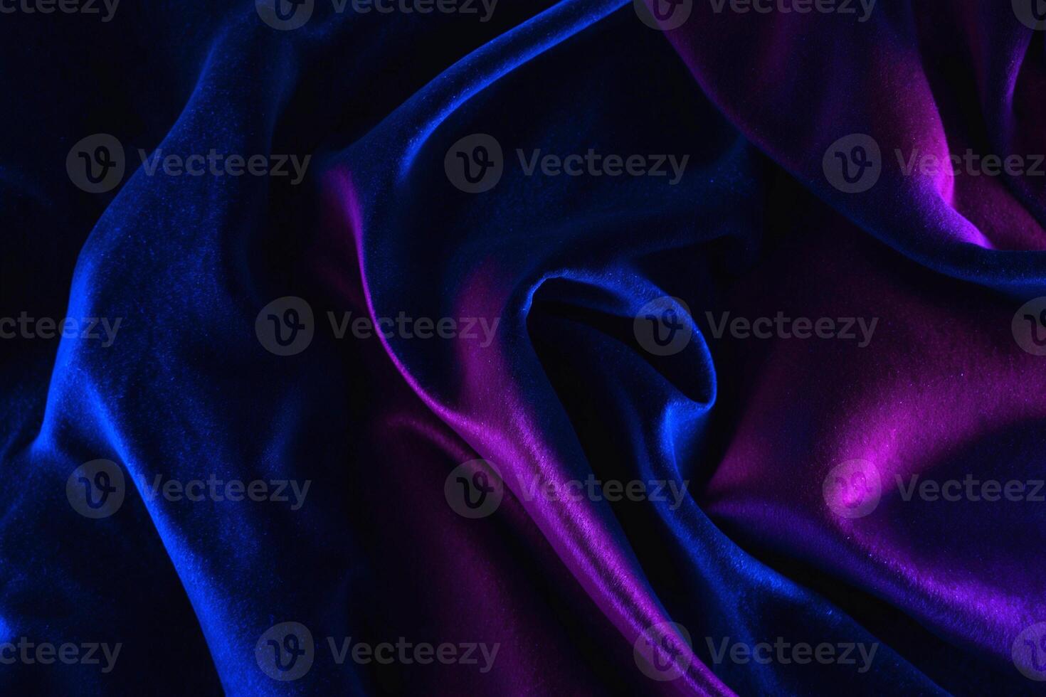 Texture, background, pattern. The fabric is dark blue, purple, red. It has a smooth matte finish. photo