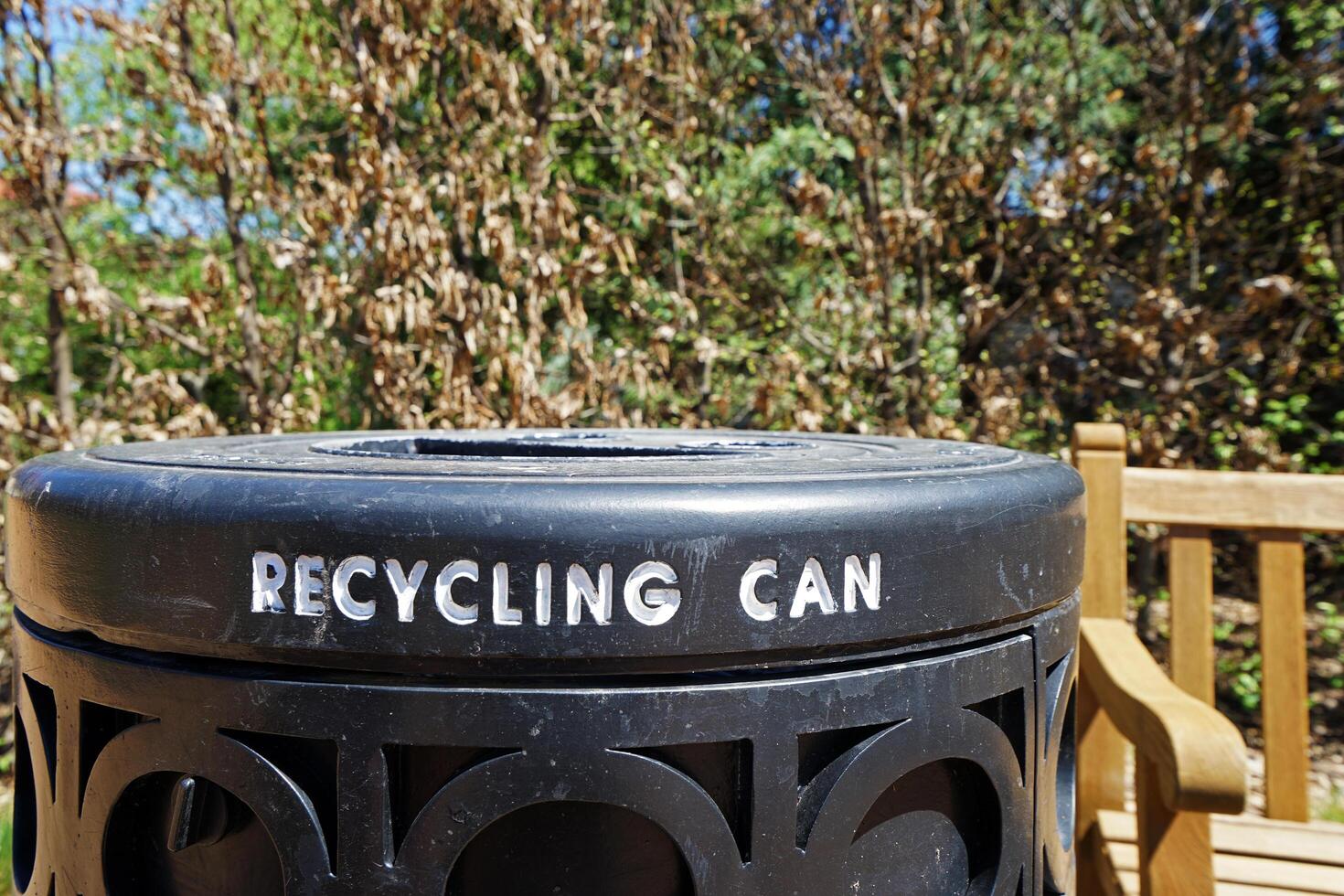 Close up black metal Recycling can in natural green public park photo