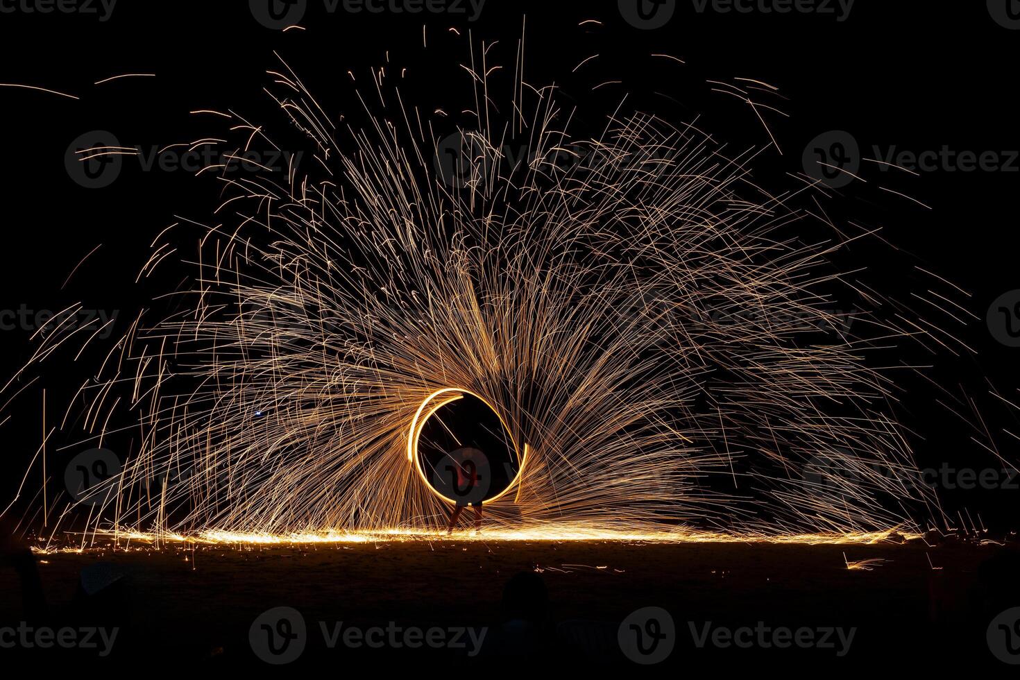 Swing fire dancing show, long exposure on the floor at the night time photo