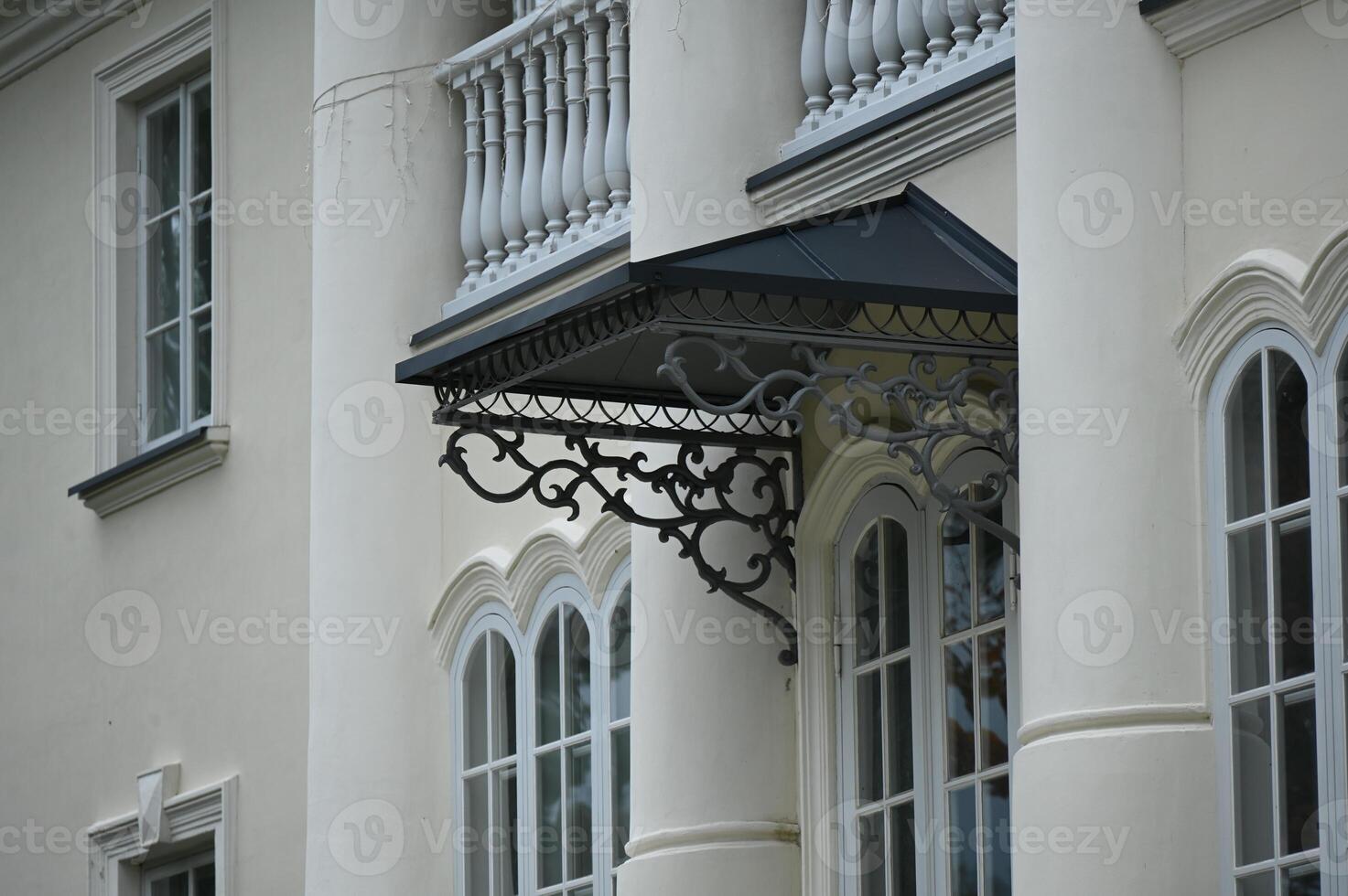 a white building with a balcony photo
