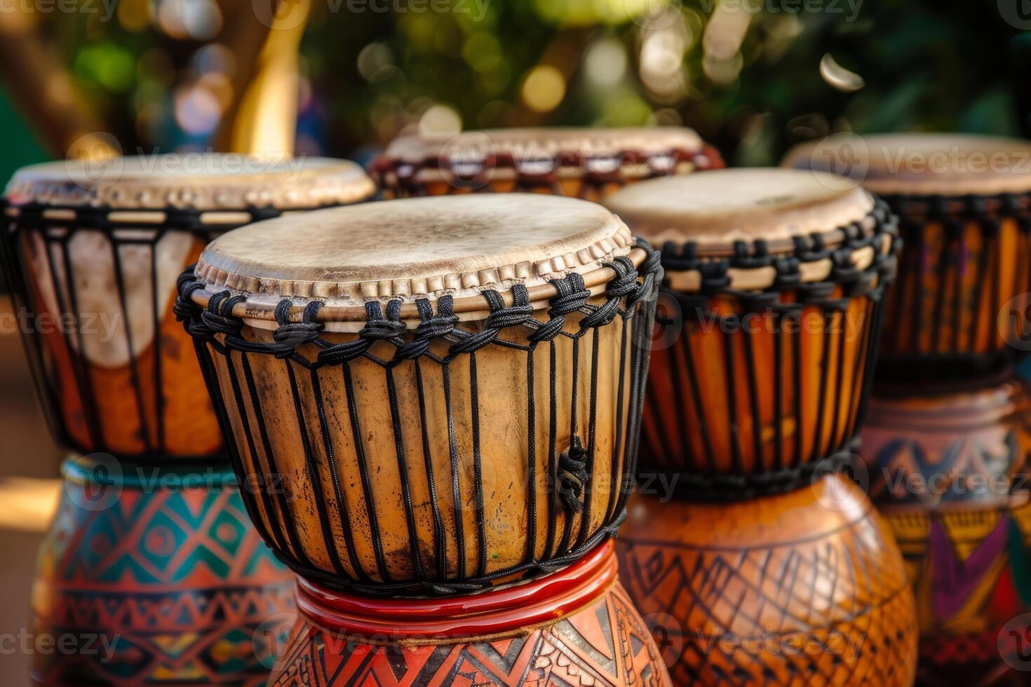 Five colorful djembe drums sitting outside on display photo