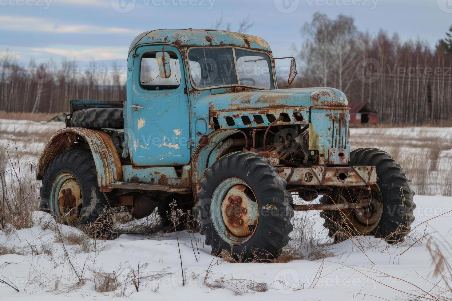 Old rusty truck slowly decomposing in snowy field photo