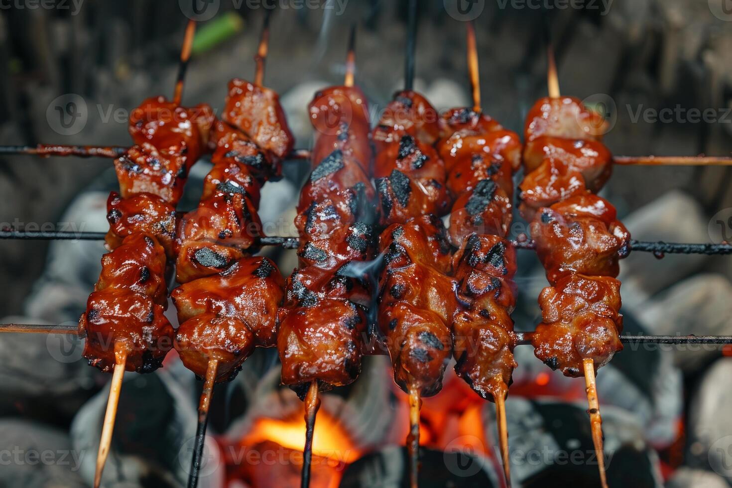 Delicious barbecue pork skewers grilling over hot coals photo