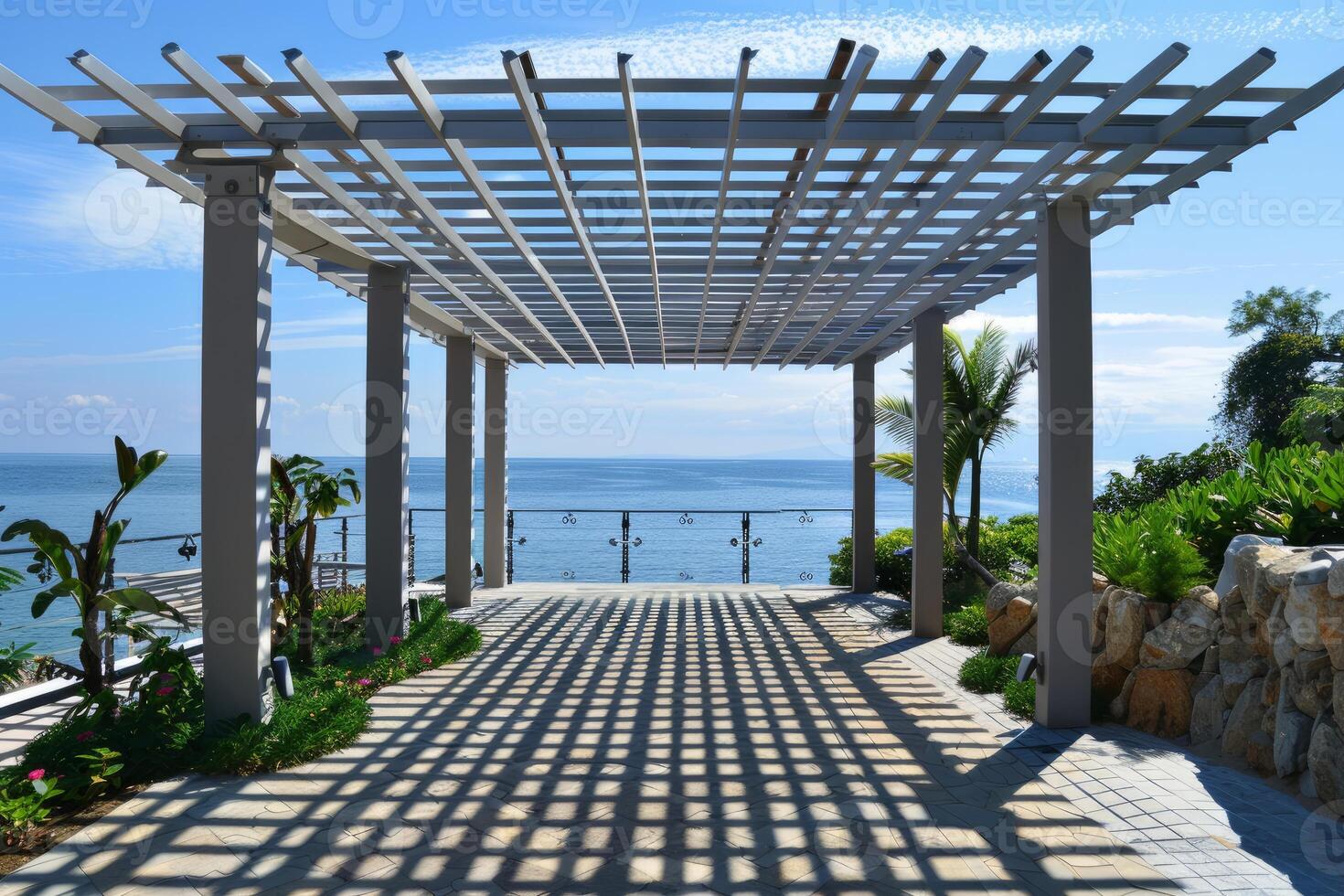 Beautiful pergola is casting shadows on the ground on a sunny day photo