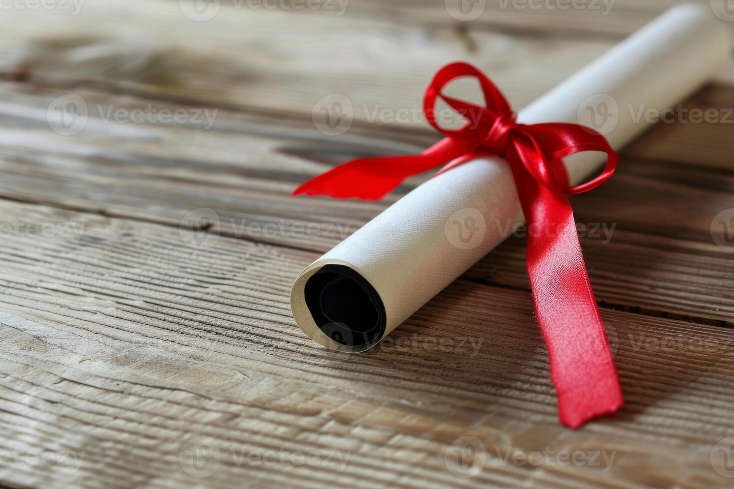 Diploma tied with red ribbon on rustic wooden table photo