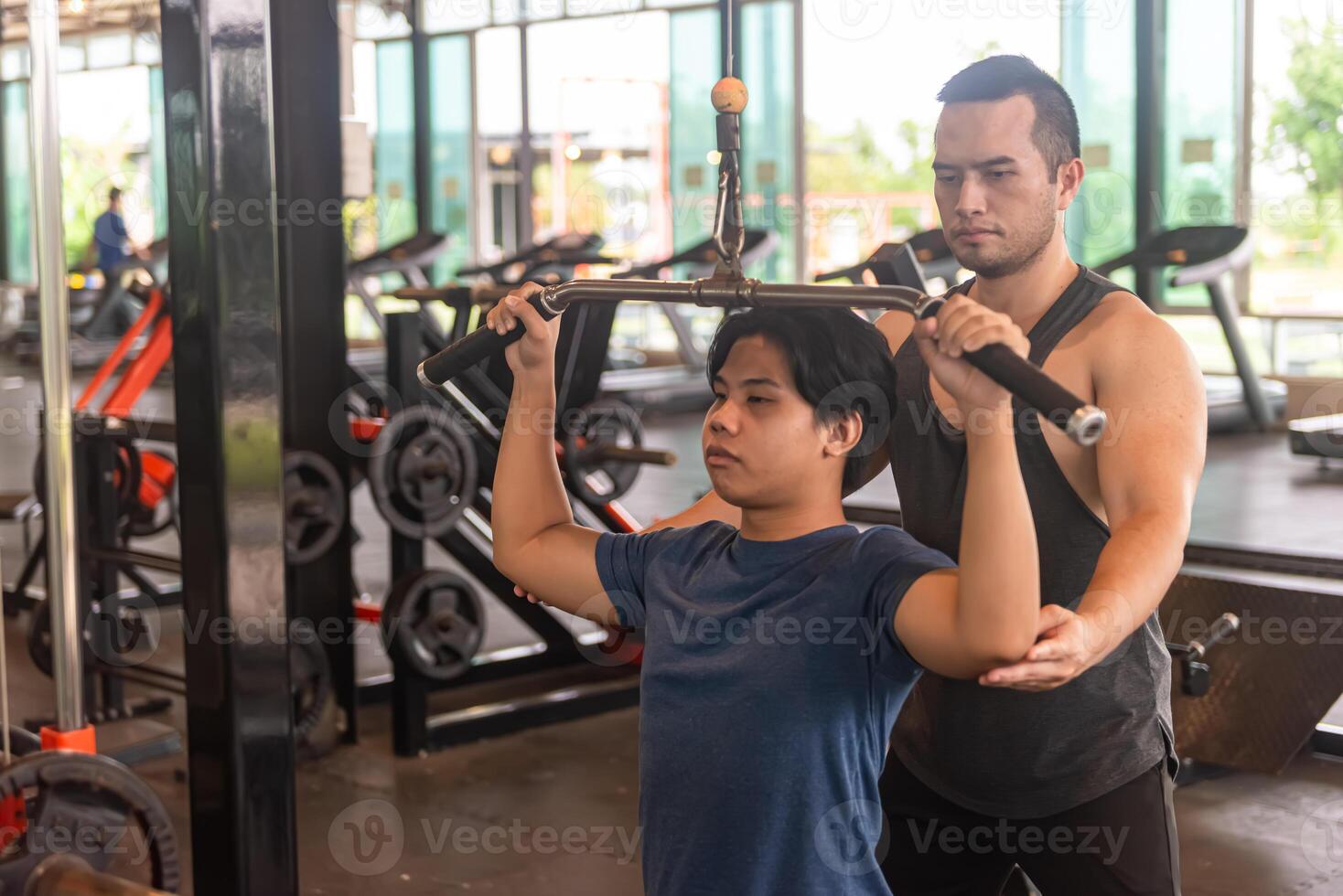 male trainer is planning an exercise program for a client who wants to improve their physical shape in a fitness center photo