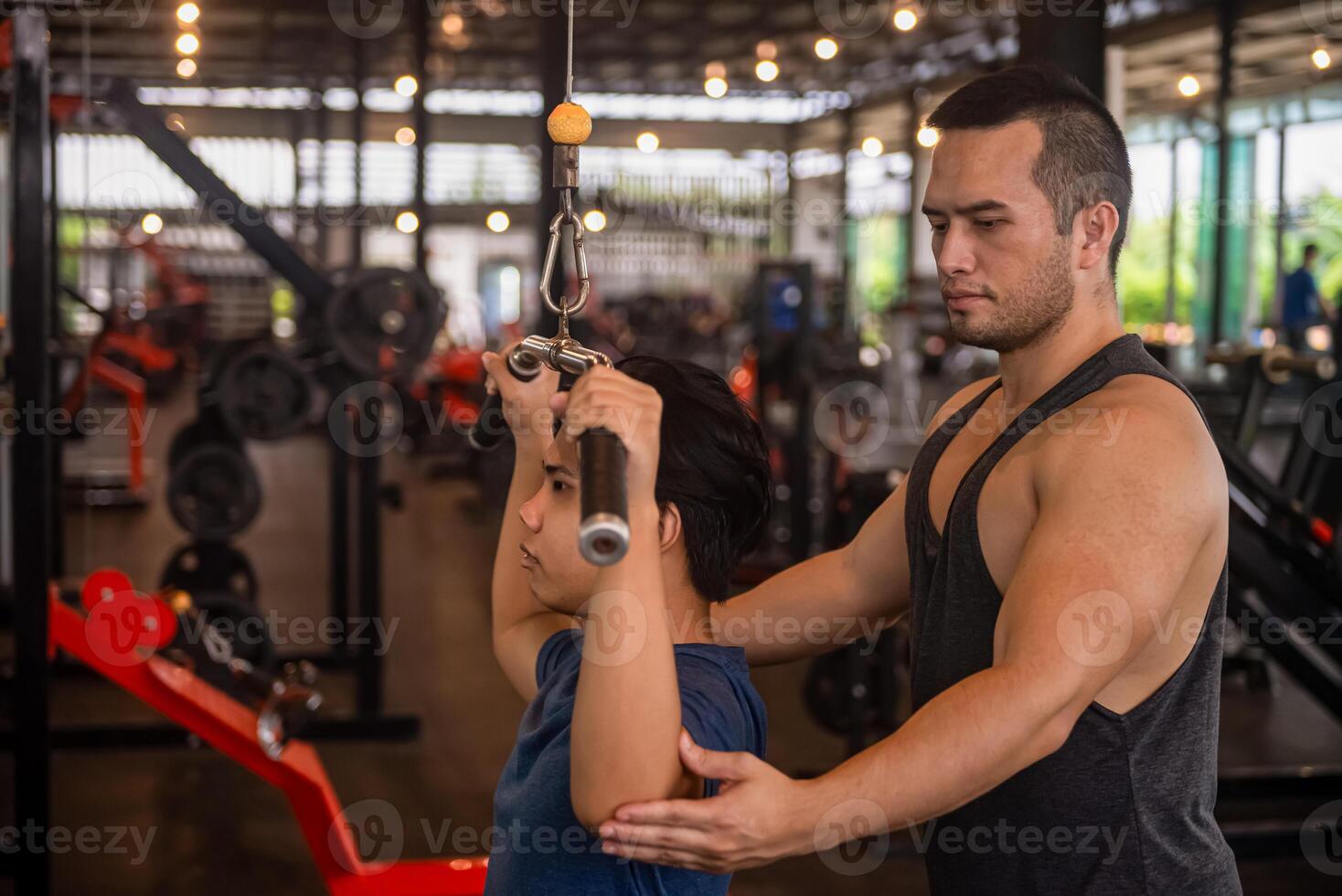male trainer is planning an exercise program for a client who wants to improve their physical shape in a fitness center photo