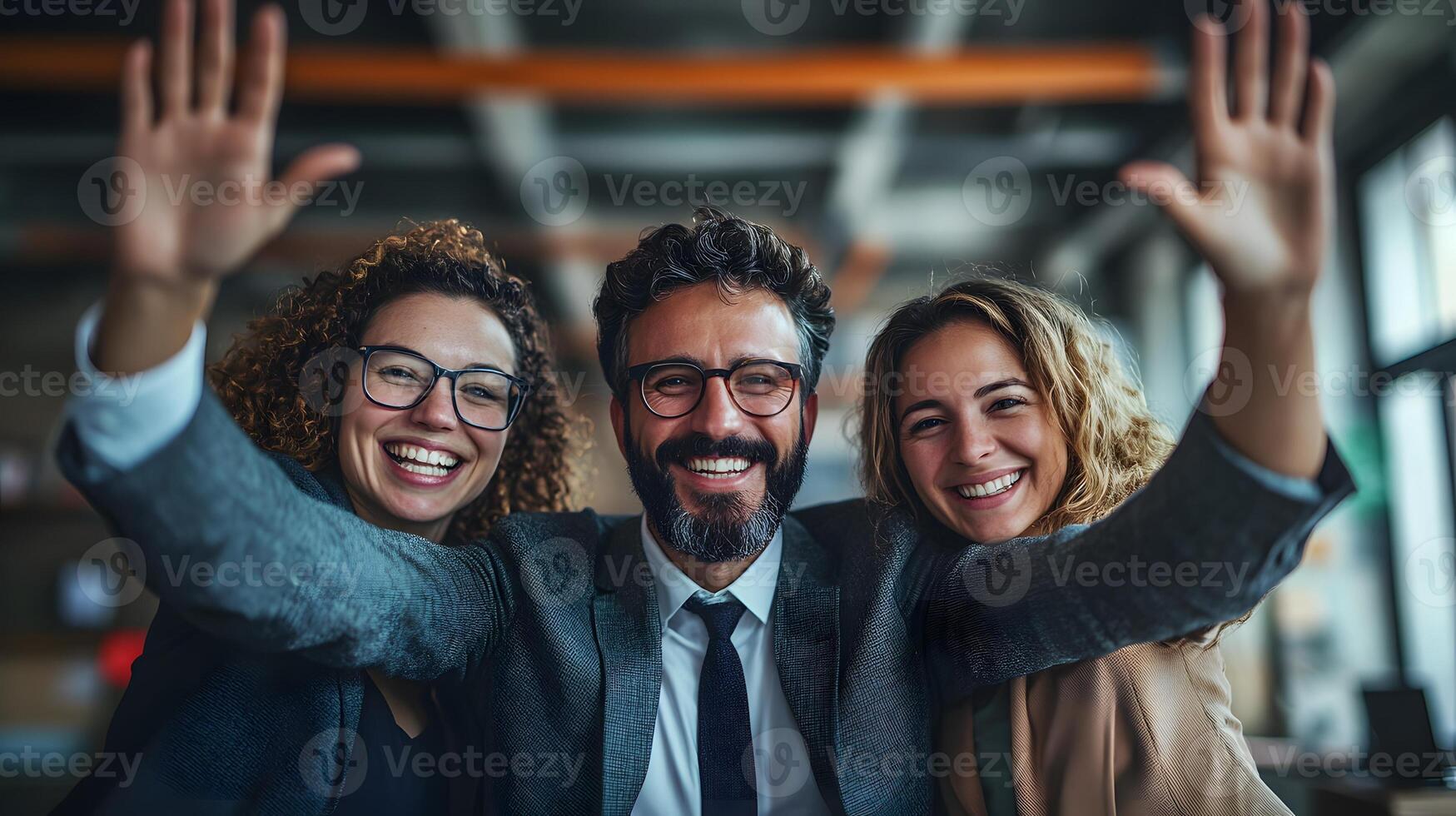 A group of business professionals gathered in an industrial loft office, hands on the table, preparing for an appointment with cheerful spirits photo