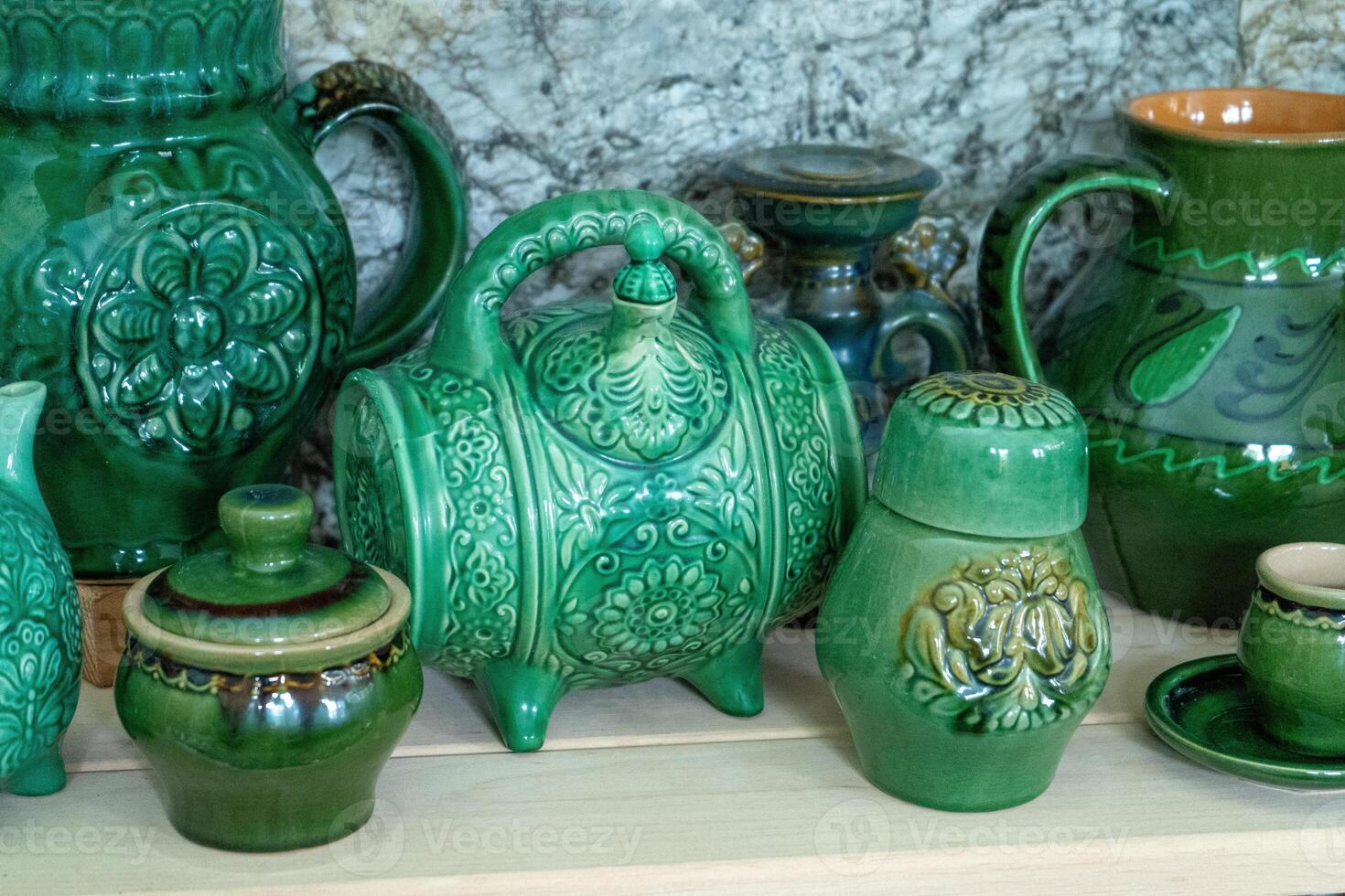 Various decanters for wine and drinks. Ukrainian clay ceramics. Green tableware. Jug photo