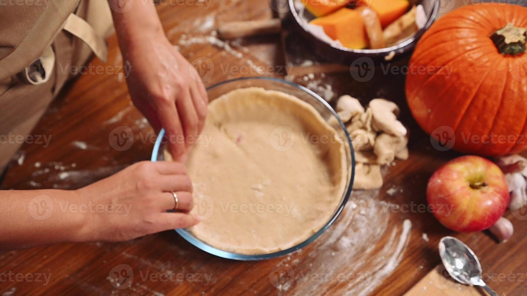 Baking preparation for fall with pumpkin, apple, and pie crust in a cozy kitchen setting photo