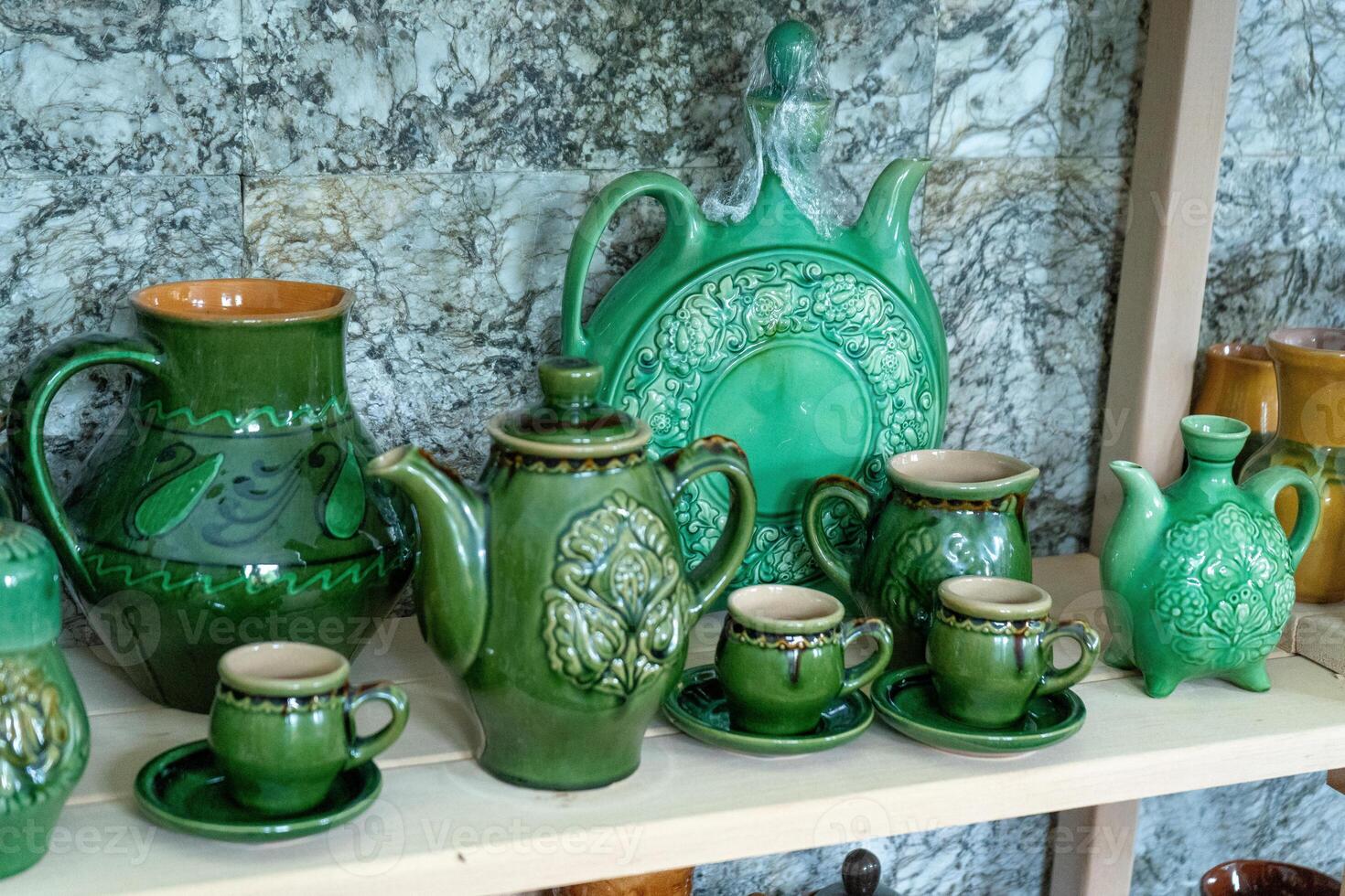 Various decanters for wine and drinks. Ukrainian clay ceramics. Green tableware. Jug photo