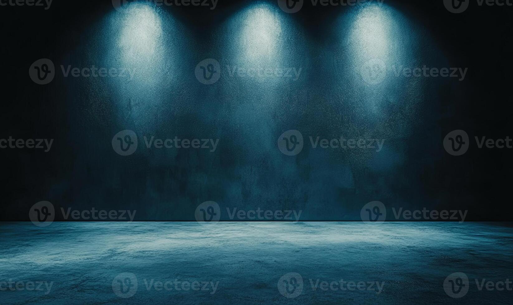 A dark room with a concrete floor and three spotlights shining on the wall. photo