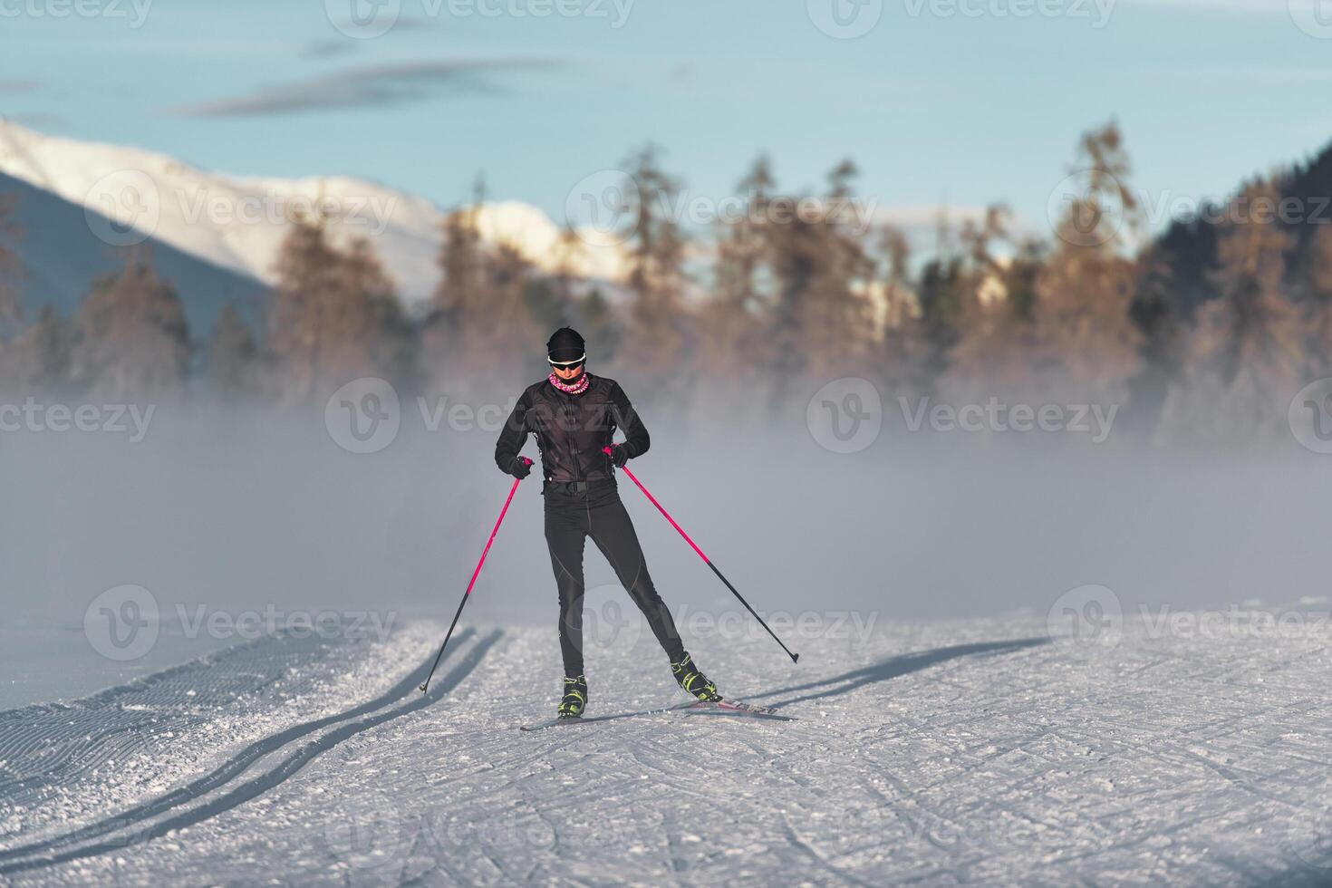 Nordic skier on free technique track photo