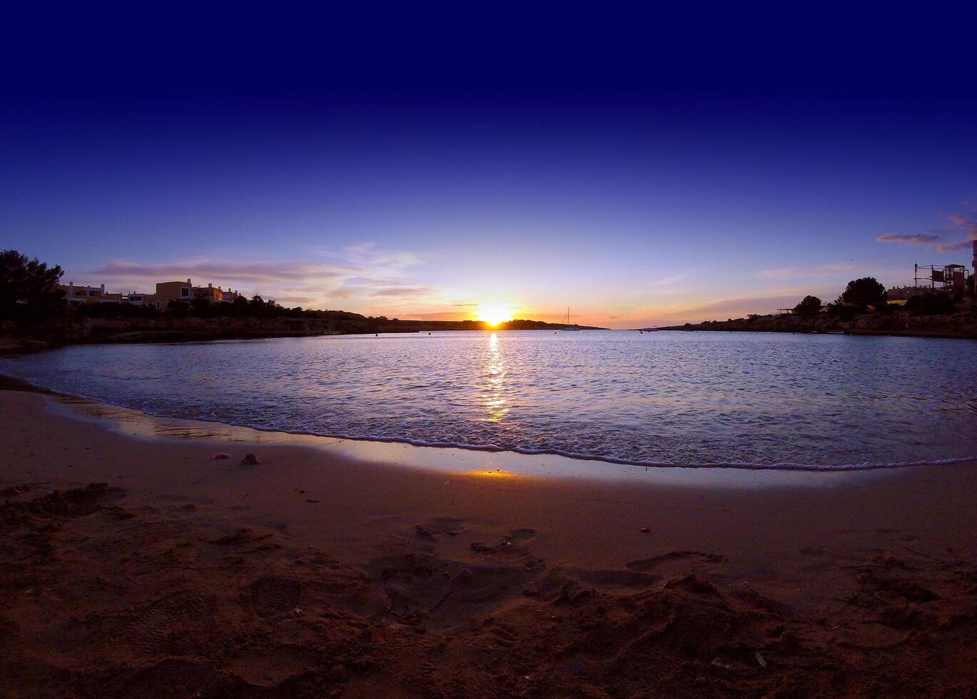 Wide angle shot of Port de Torrent, Ibiza, Spain at sundown photo