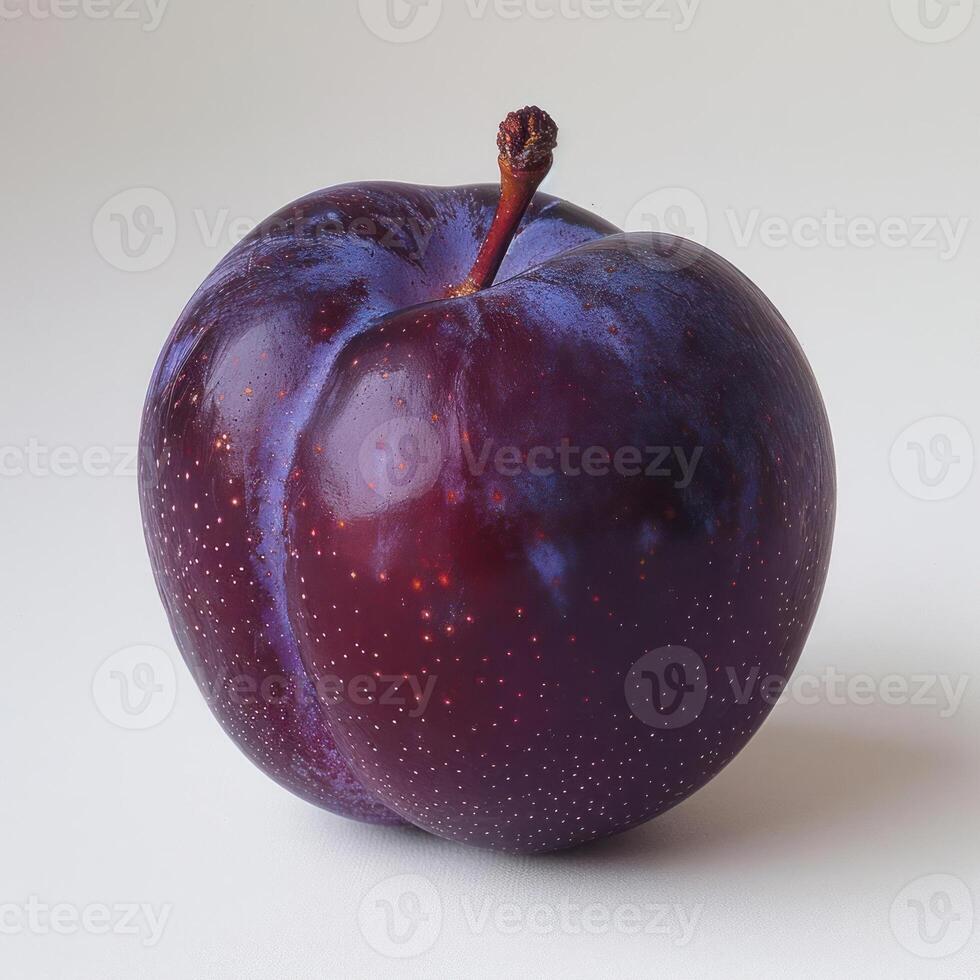 a purple apple with a red stem on a white surface photo